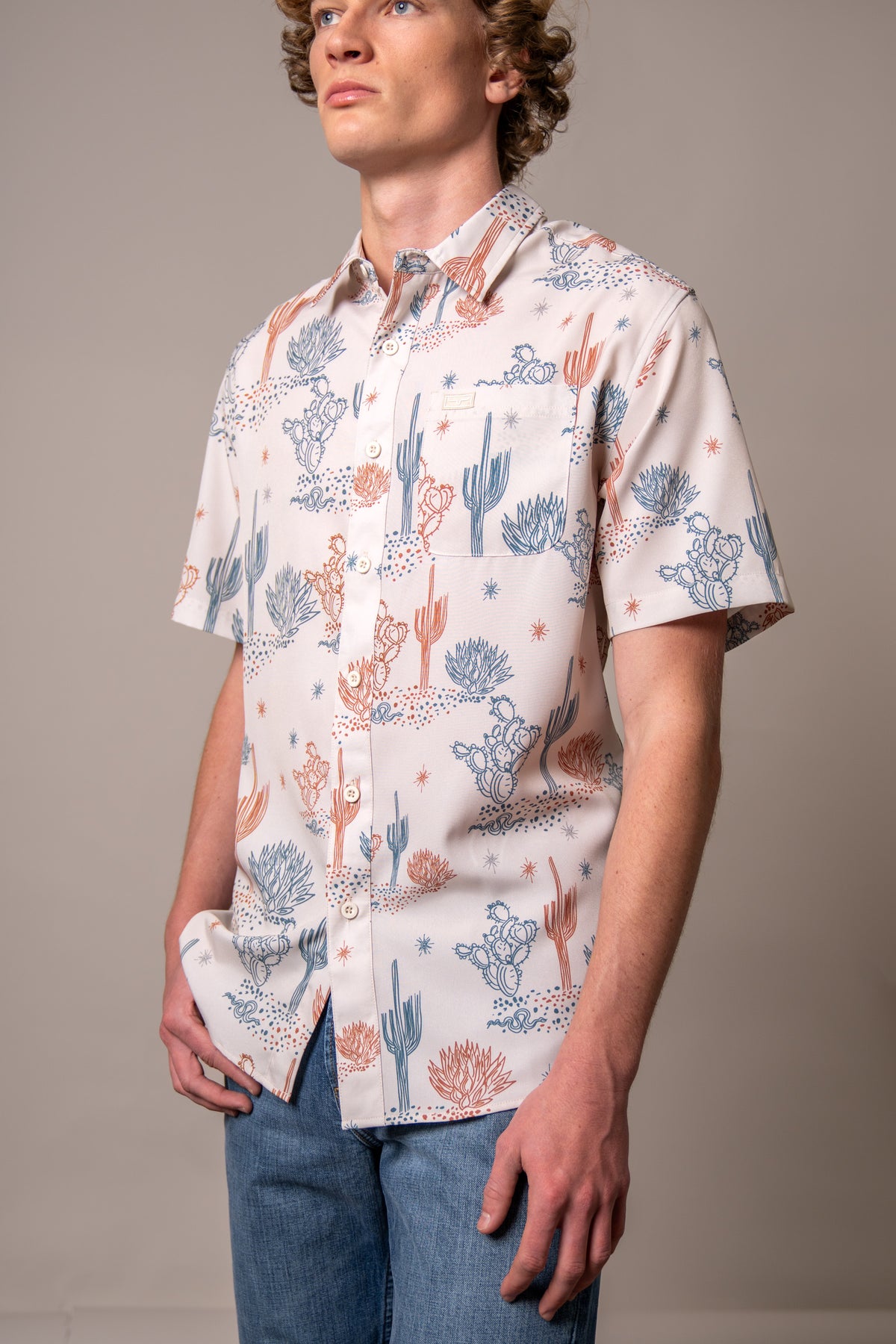 Kimes Ranch Dunn short sleeve dress shirt in Natural with a blue and orange cactus print and a chest pocket