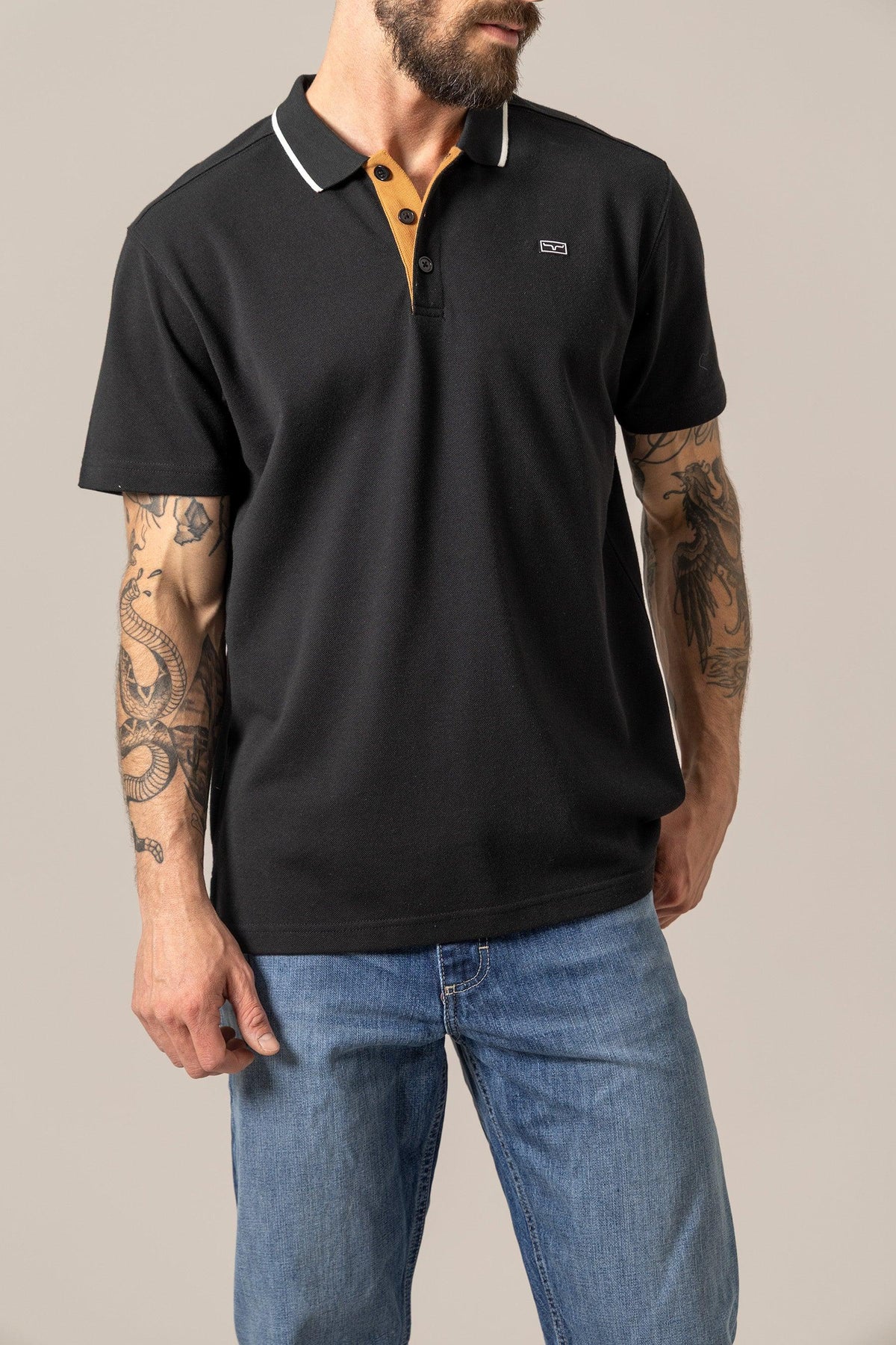 Kimes Ranch El Capitan Polo in Black with a mustard placket and white collar trim