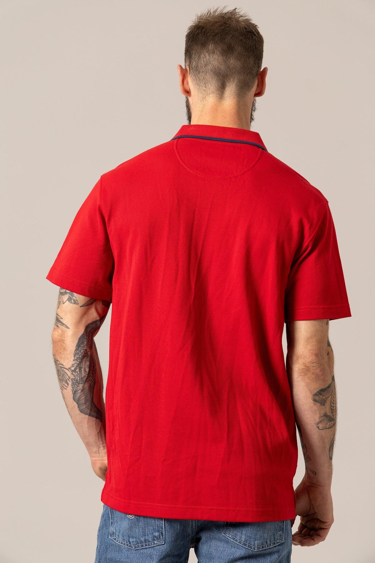 Kimes Ranch El Capitan Polo in Red, back view, with a navy contrast collar and short sleeves