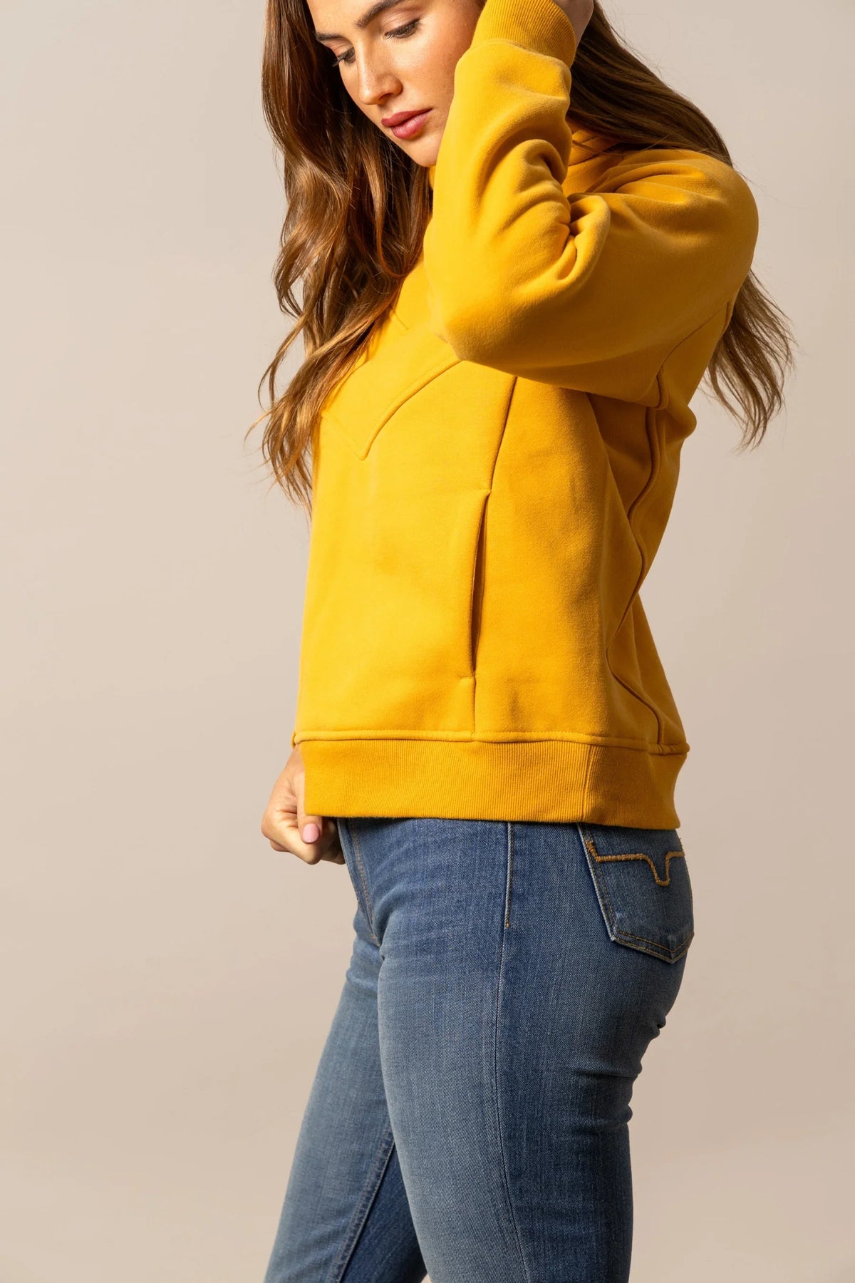 Kimes Ranch Ella hoodie in Yellow Ochre, side view, with a kangaroo pocket and ribbed hem