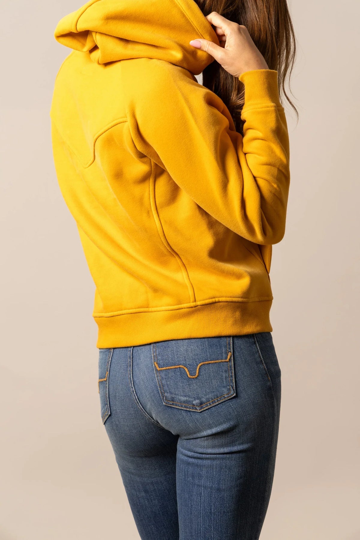 Kimes Ranch Ella hoodie in Yellow Ochre, side view, with a hood, long sleeves, and a back yoke seam