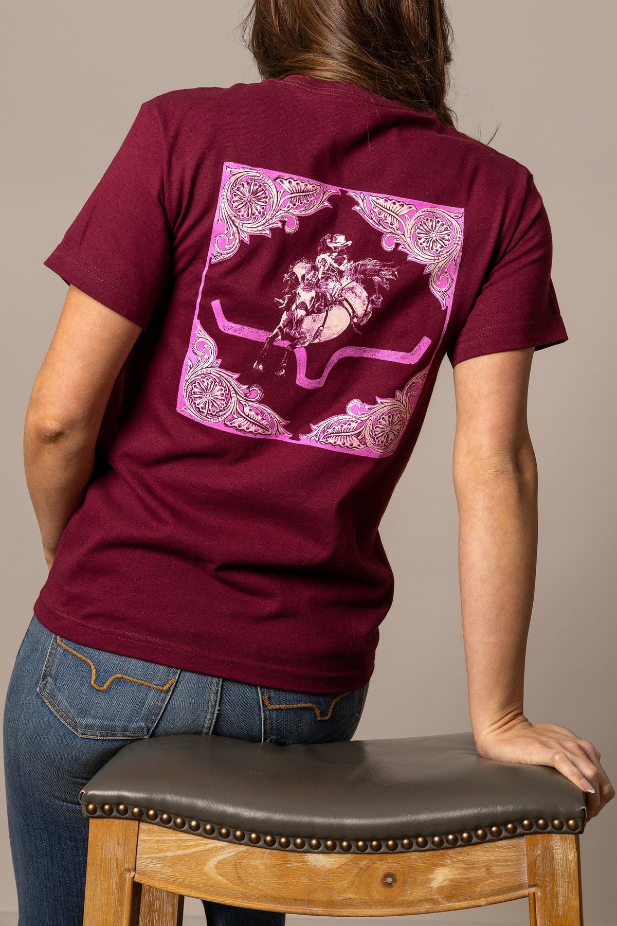 Kimes Ranch Fallon Bandana shirt in Burgundy, back view, with a pink and white graphic of a rodeo rider on the back