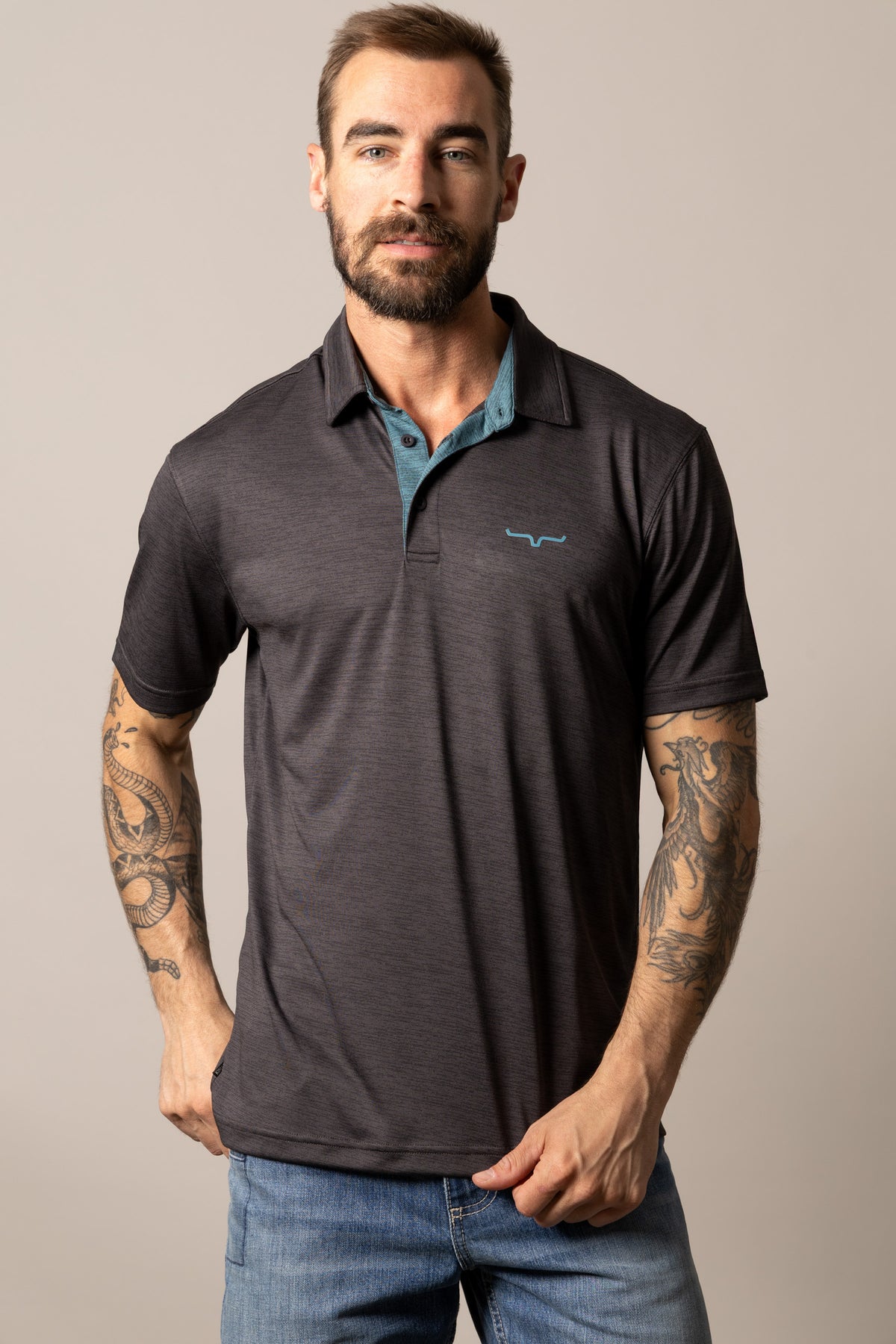 Kimes Ranch Fletcher polo in Black with a teal contrast inner collar and Kimes Ranch logo on the chest
