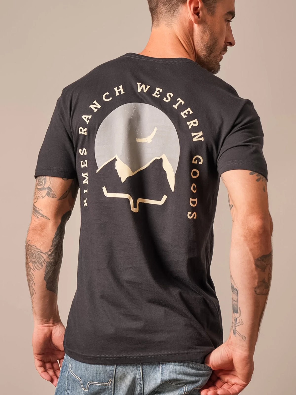Kimes Ranch Flying High, back view, shirt with a large graphic of mountains and a bird with text Kimes Ranch Western Goods