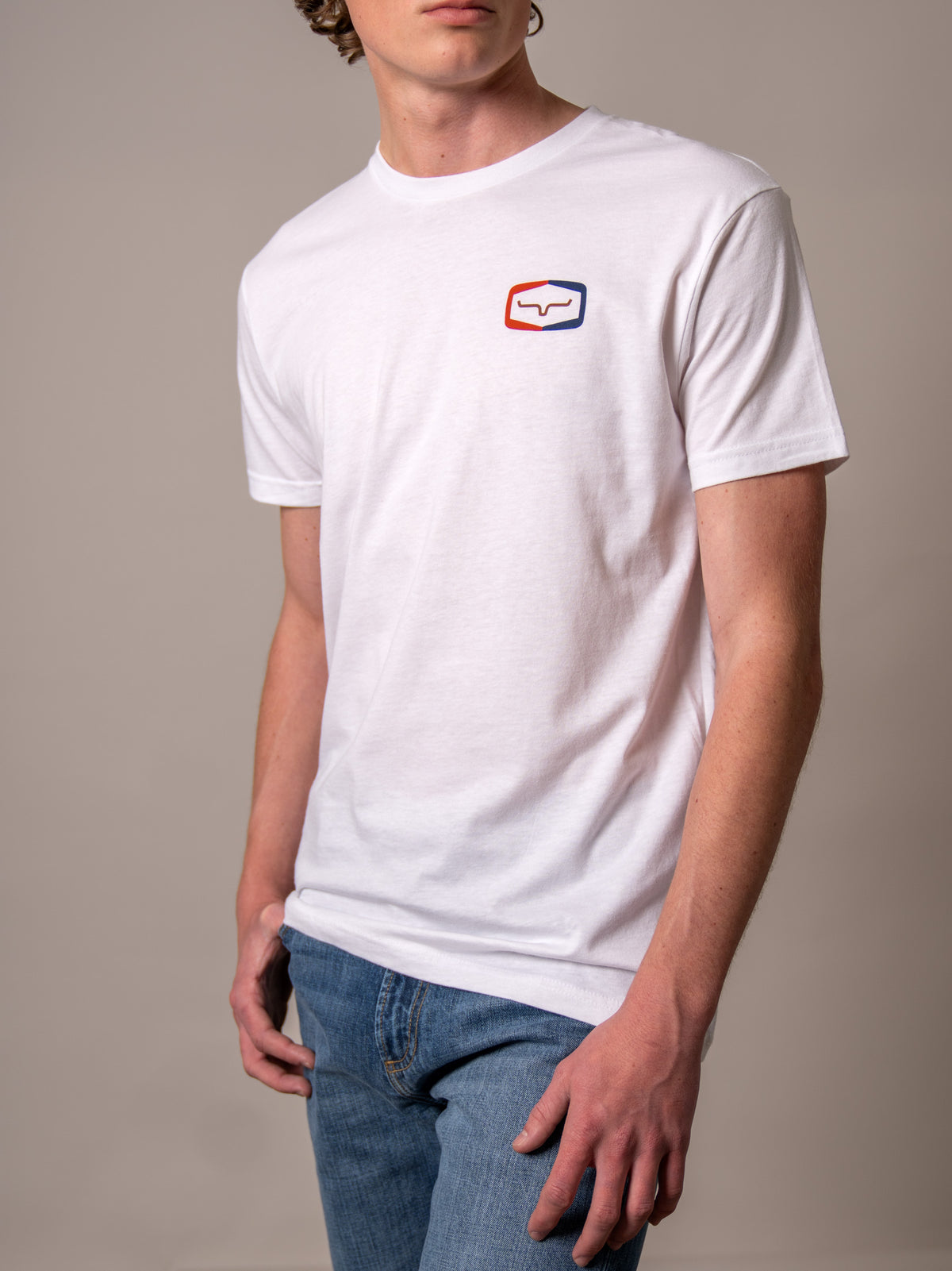 Kimes Ranch Framework White short sleeve shirt with a red and blue logo on the chest
