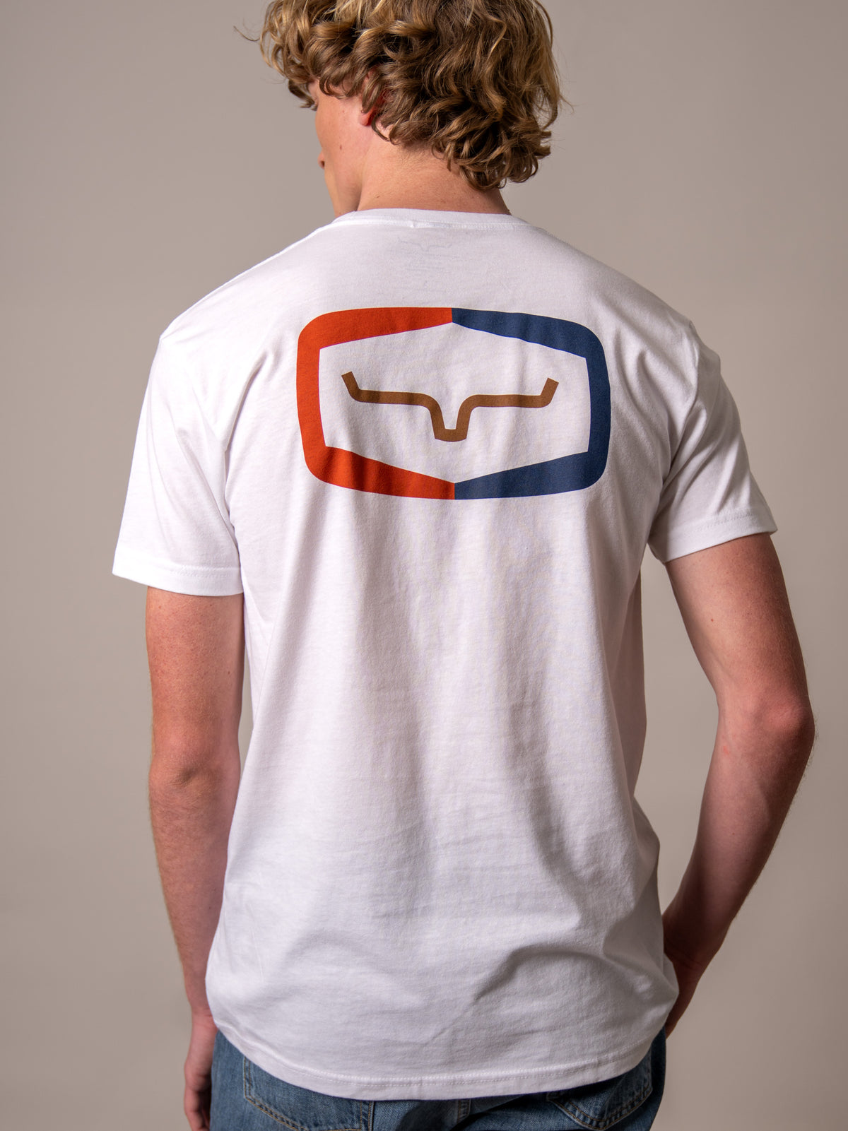 Kimes Ranch Framework shirt in White, back view, with a back graphic of a stylized Kimes Ranch logo in a red and blue frame