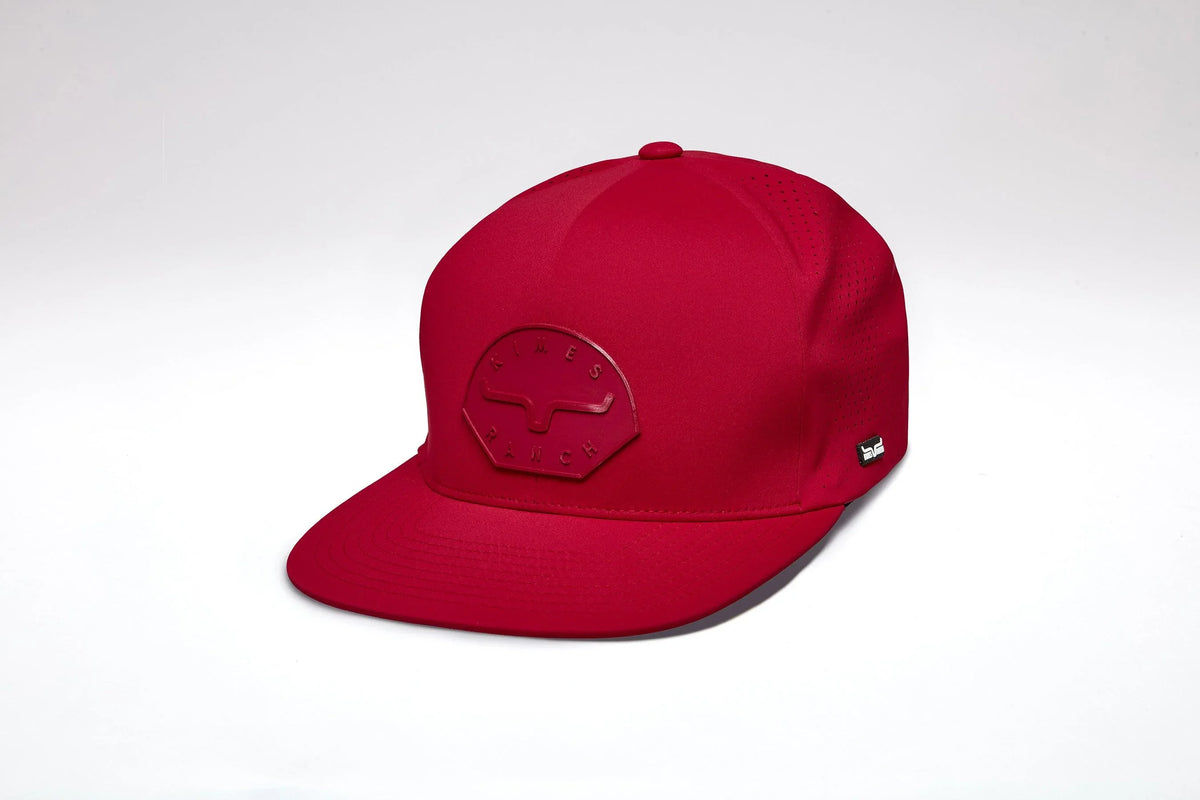 Kimes Ranch Gilette, side view, Red hat with a flat brim and a tonal Kimes Ranch logo patch on the front