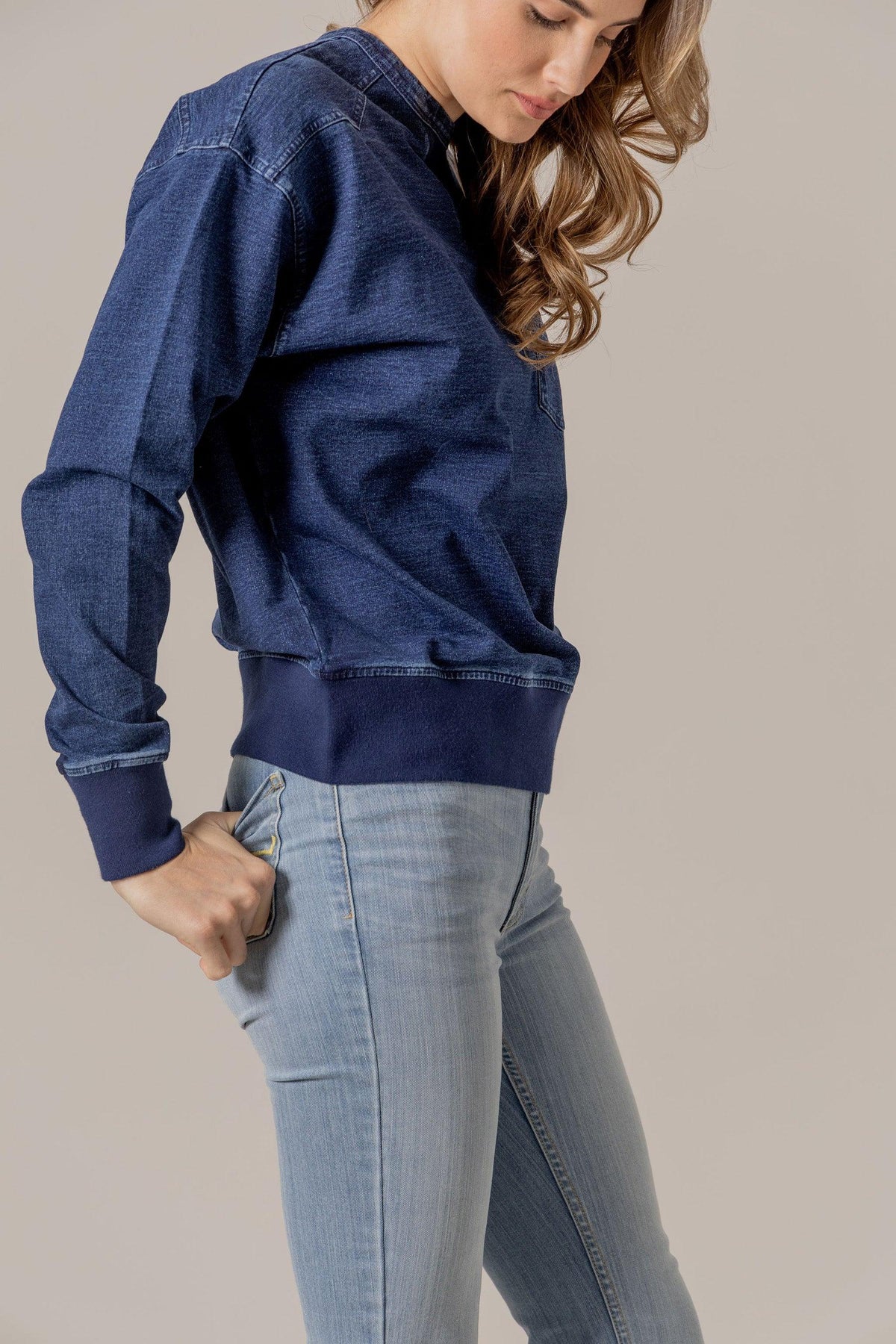 Kimes Ranch Gina Western Crew sweatshirt in Indigo Blue, side view, with long sleeves and a ribbed hem
