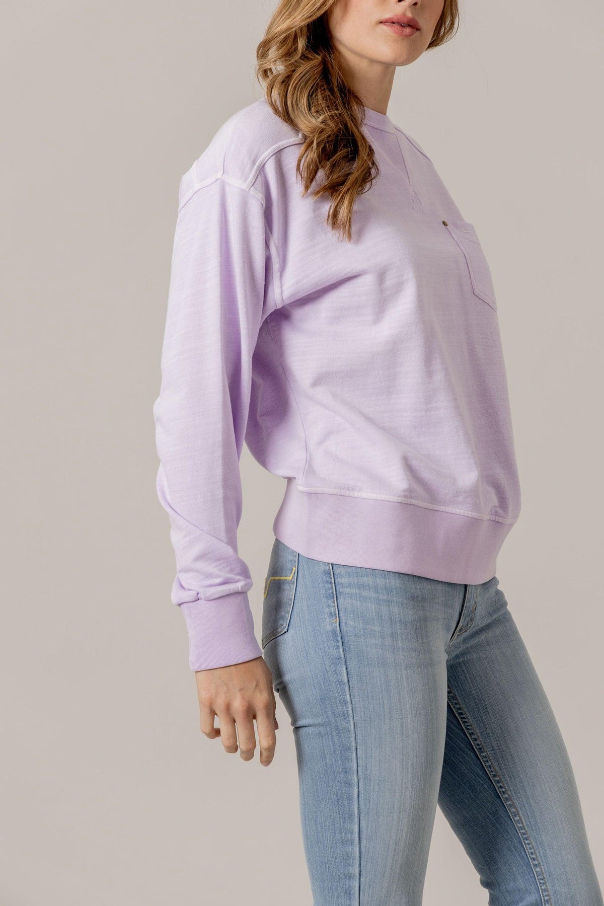 Kimes Ranch Gina Western Crew sweatshirt in Lavender, side view, with a chest pocket and ribbed cuffs