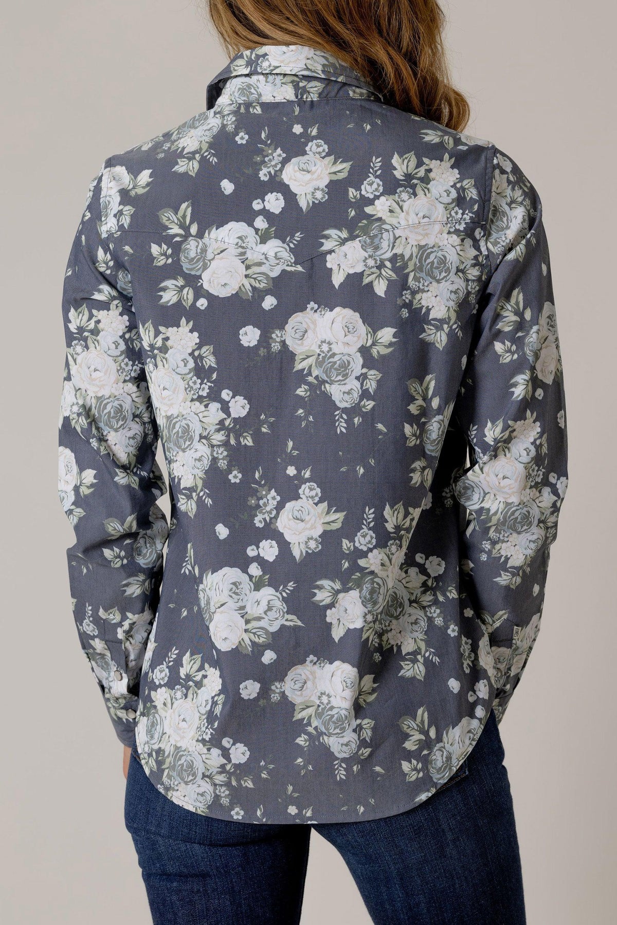 Kimes Ranch Ginny Snap top in Blue, back view, with a white floral print and long sleeves