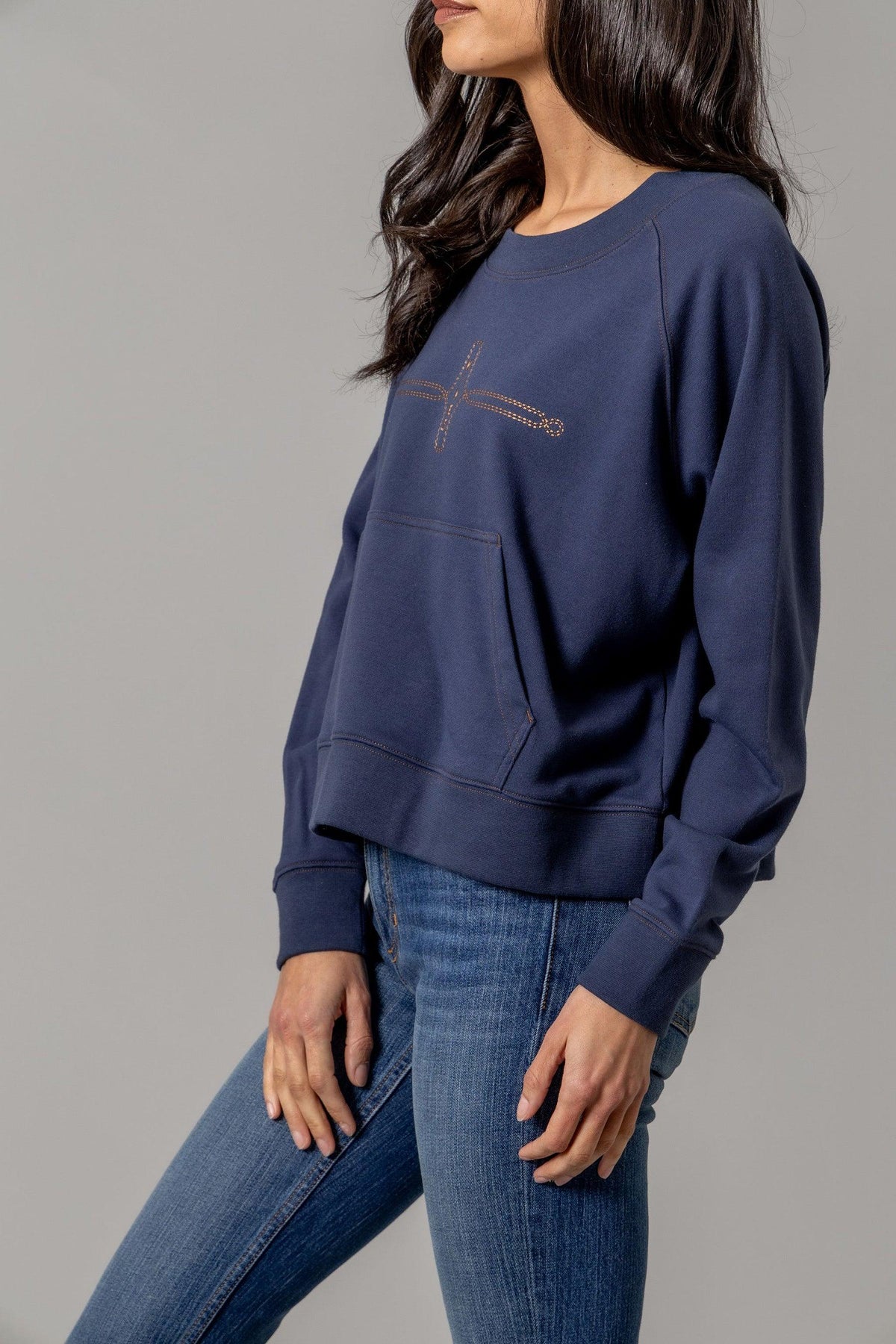 Kimes Ranch Gracie Cropped Crewneck sweatshirt in Blue, side view, with a front kangaroo pocket and Kimes Ranch logo