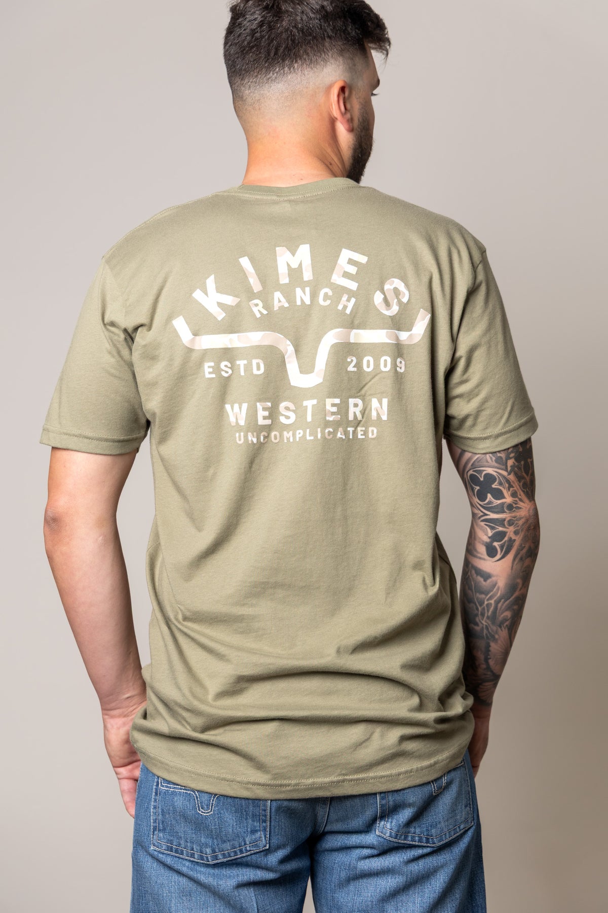 Kimes Ranch Grandview shirt in Light Olive, back view, with back graphic reading KIMES RANCH ESTD 2009 WESTERN UNCOMPLICATED