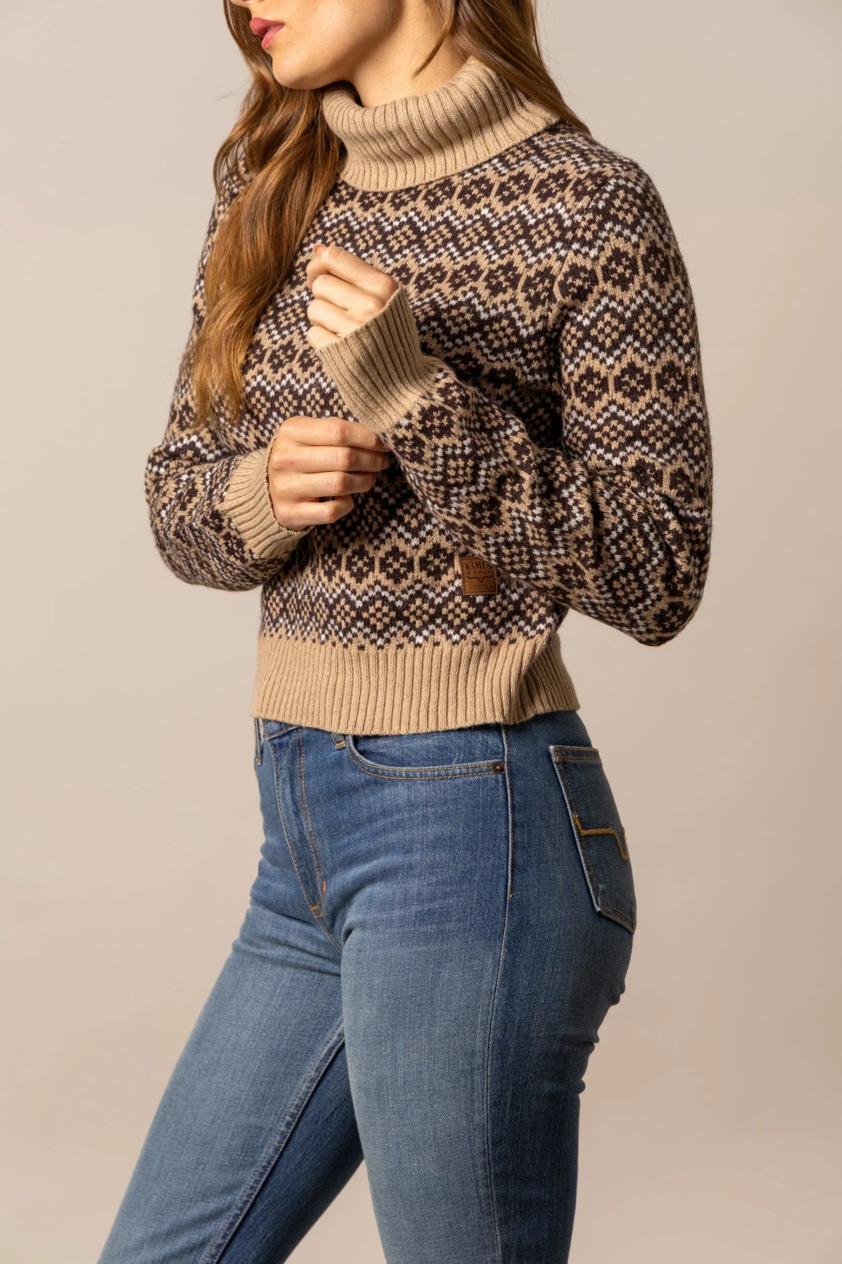 Kimes Ranch Hazel Turtleneck sweater in Coffee, side view, with a geometric knit pattern and ribbed cuffs