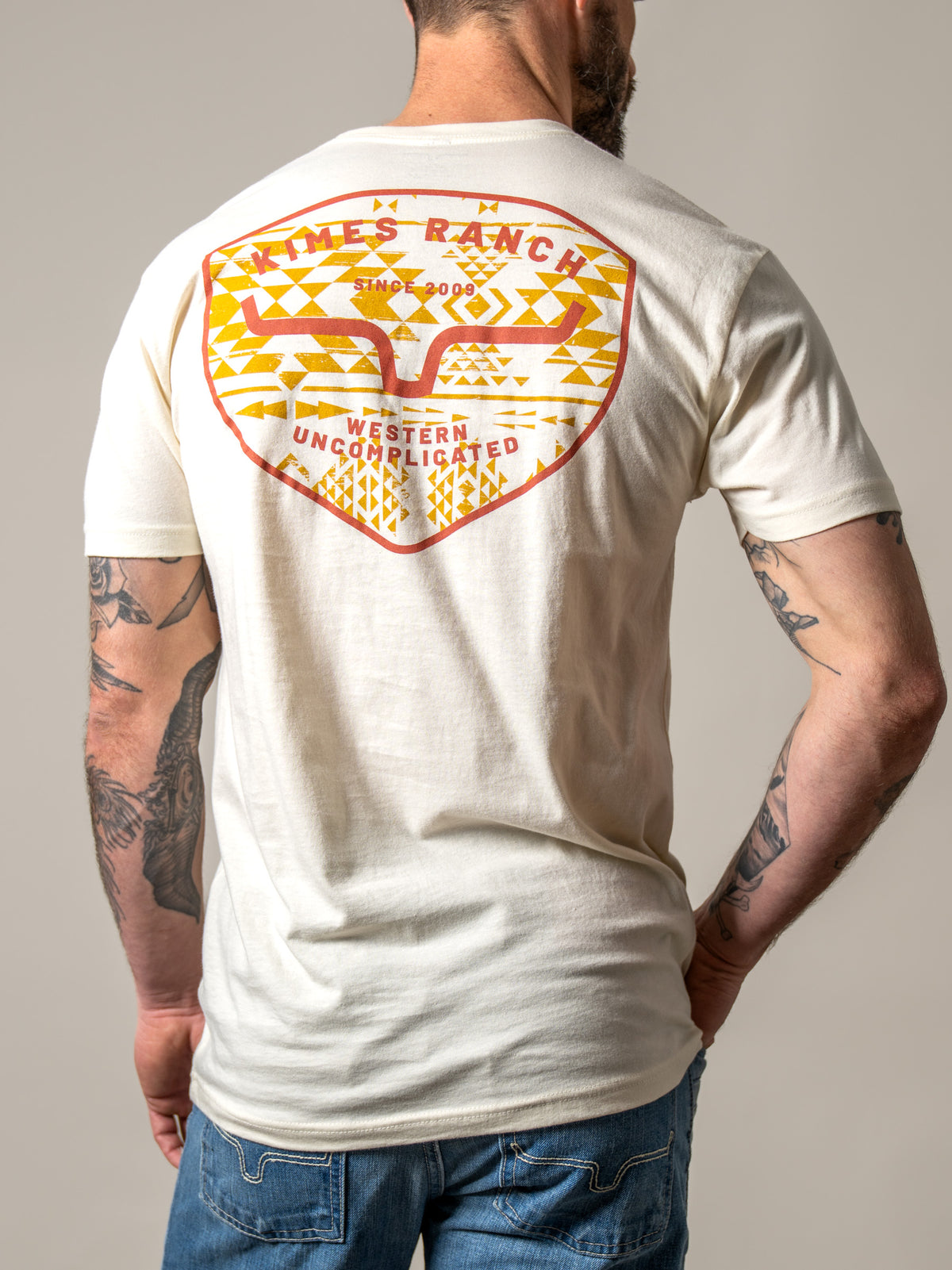 Kimes Ranch Honor shirt in Natural, back view, with a large back graphic featuring the Kimes Ranch logo