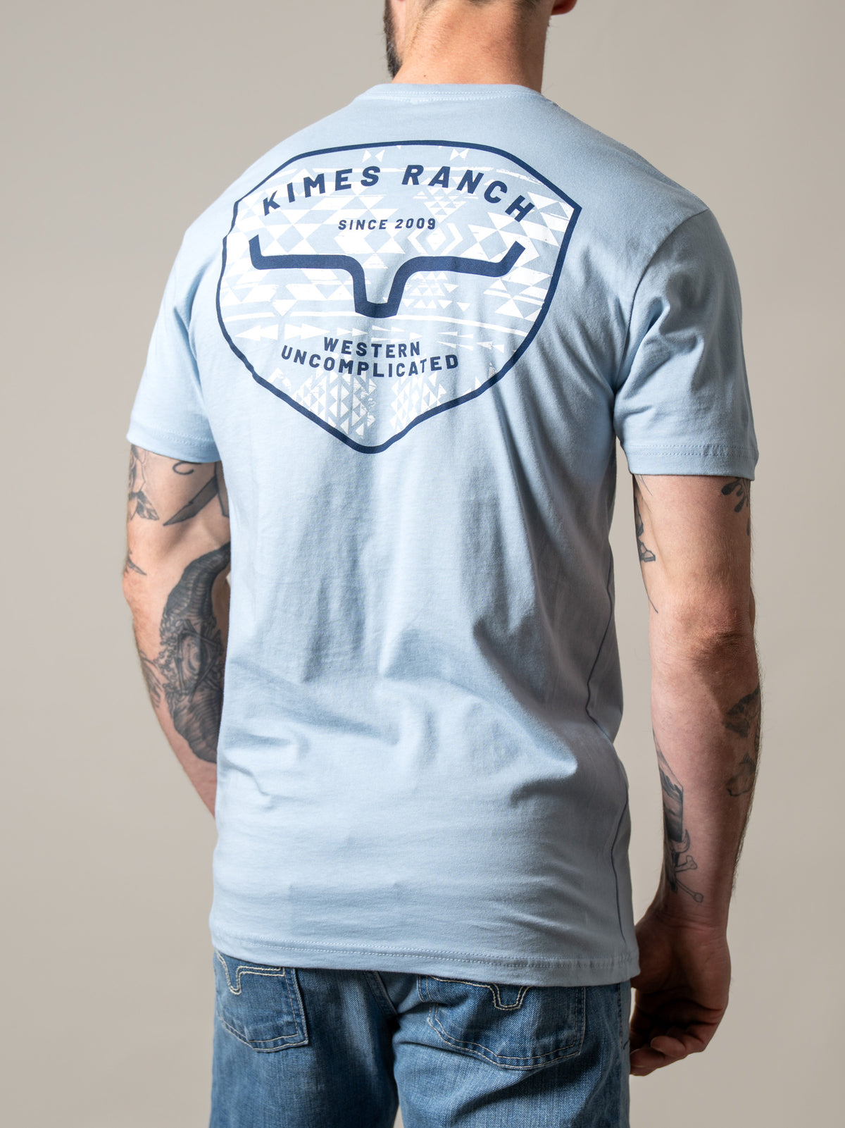 Kimes Ranch Honor, back view, shirt in Stonewash with back graphic featuring the Kimes Ranch logo