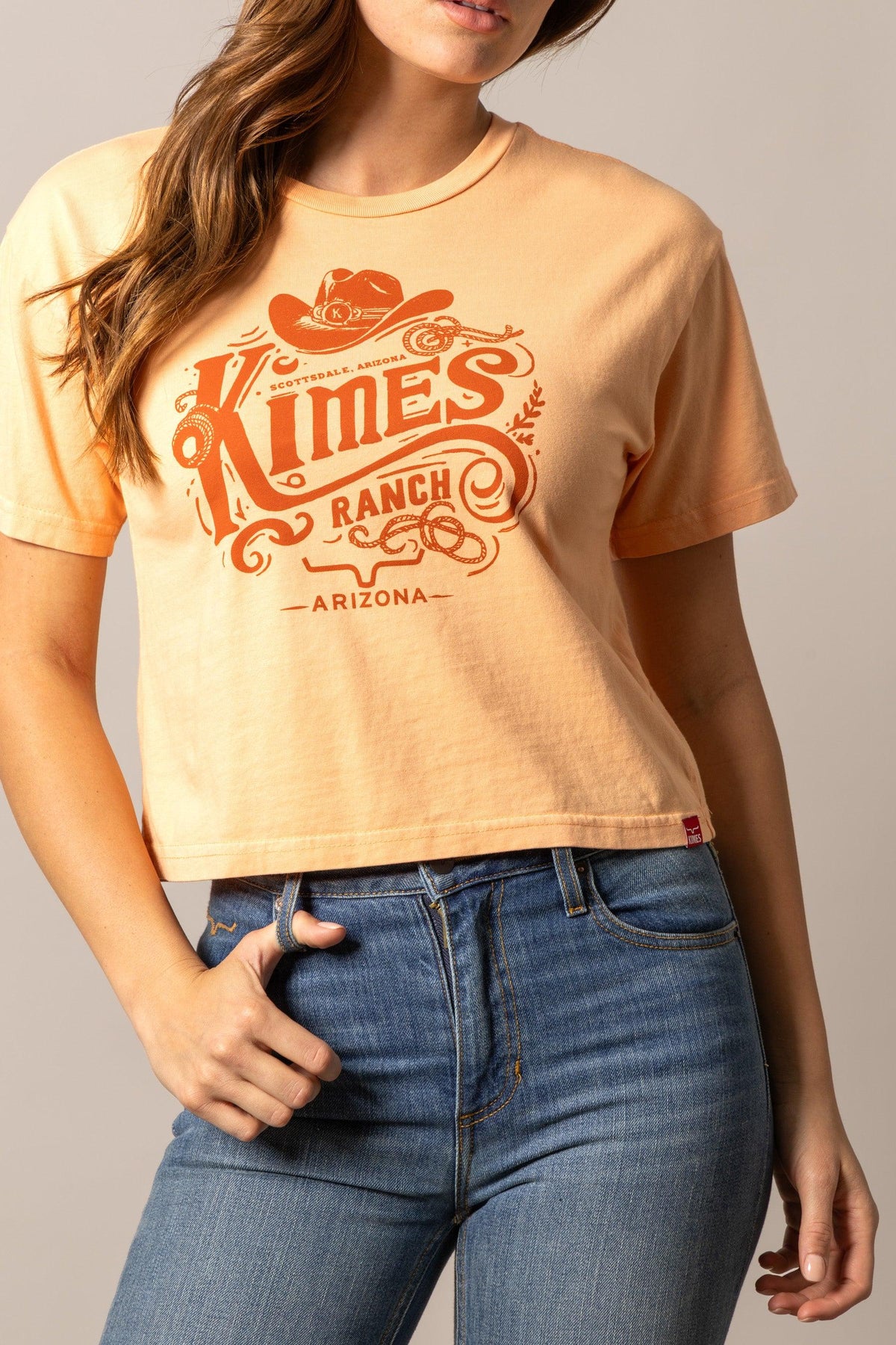 Kimes Ranch Invitation shirt in Peach with a vintage graphic featuring a cowboy hat and the words Scottsdale Arizona