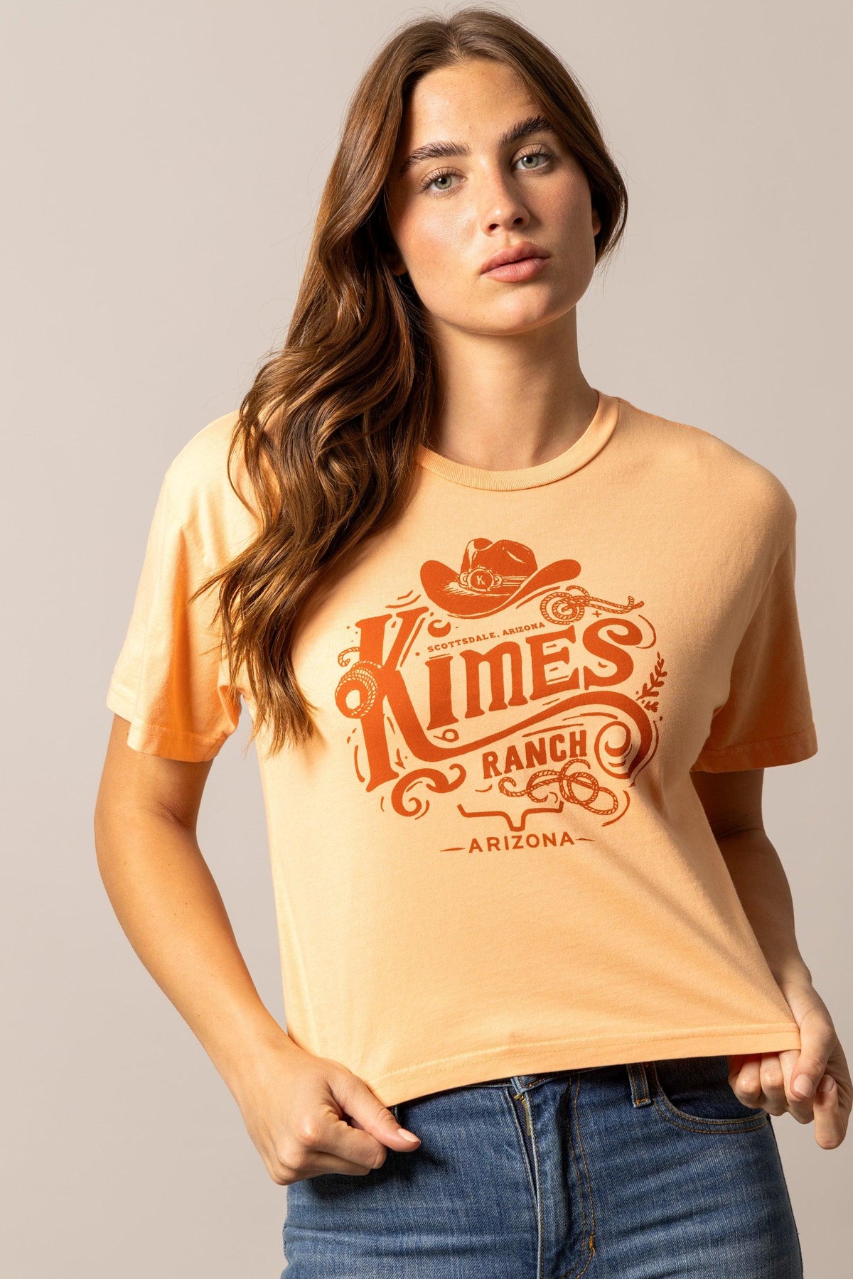 Kimes Ranch Invitation shirt in Peach with a vintage graphic featuring a cowboy hat and the text Scottsdale Arizona