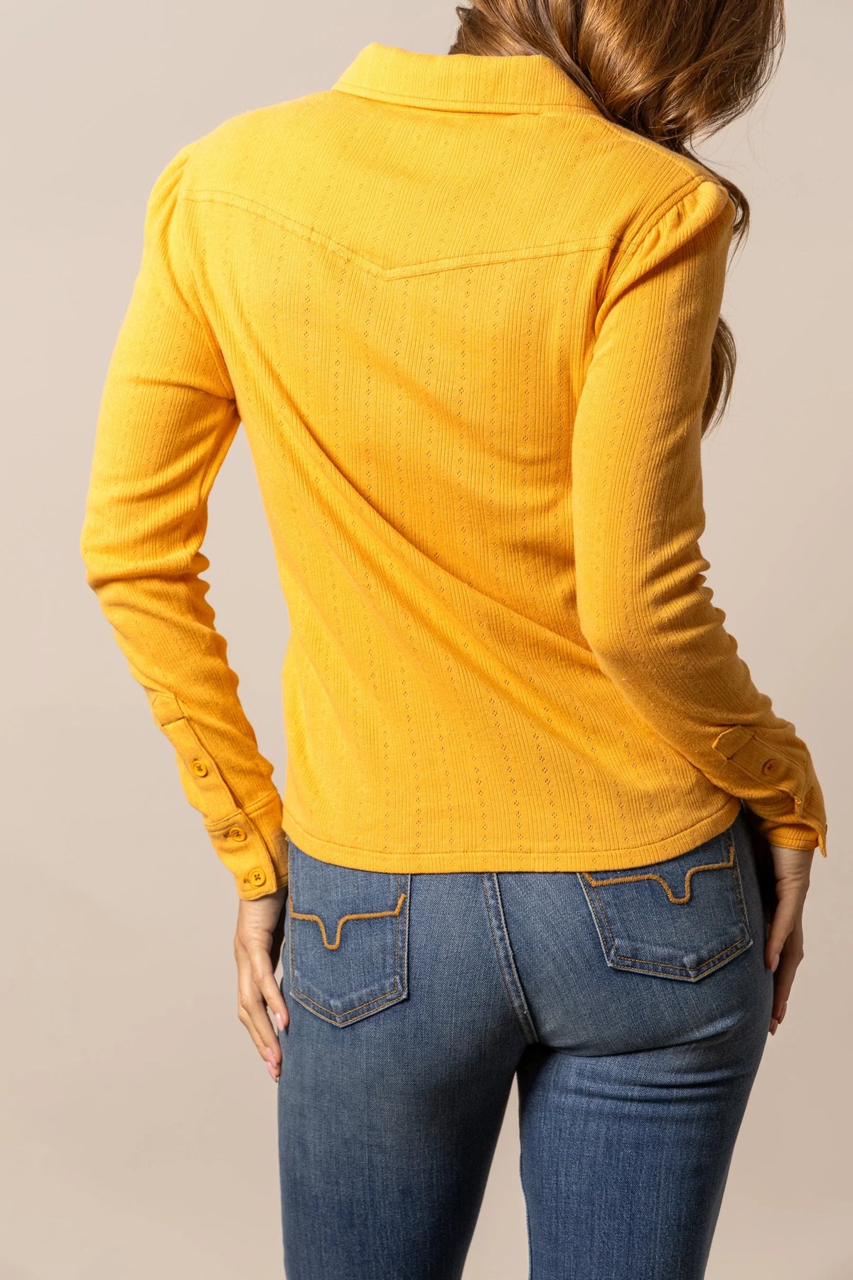 Kimes Ranch Isabel Pointelle top in Yellow Ochre, back view, with a back yoke and long sleeves