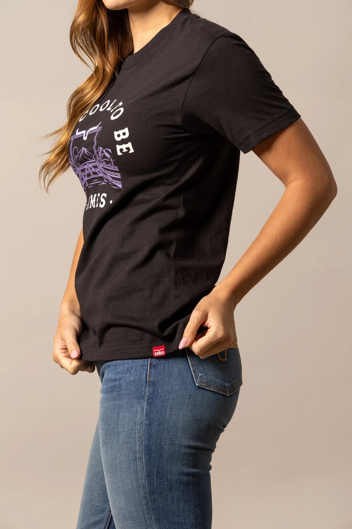 Kimes Ranch It's Cool to be Kimes, side view, Black short sleeve shirt with a purple and white graphic print