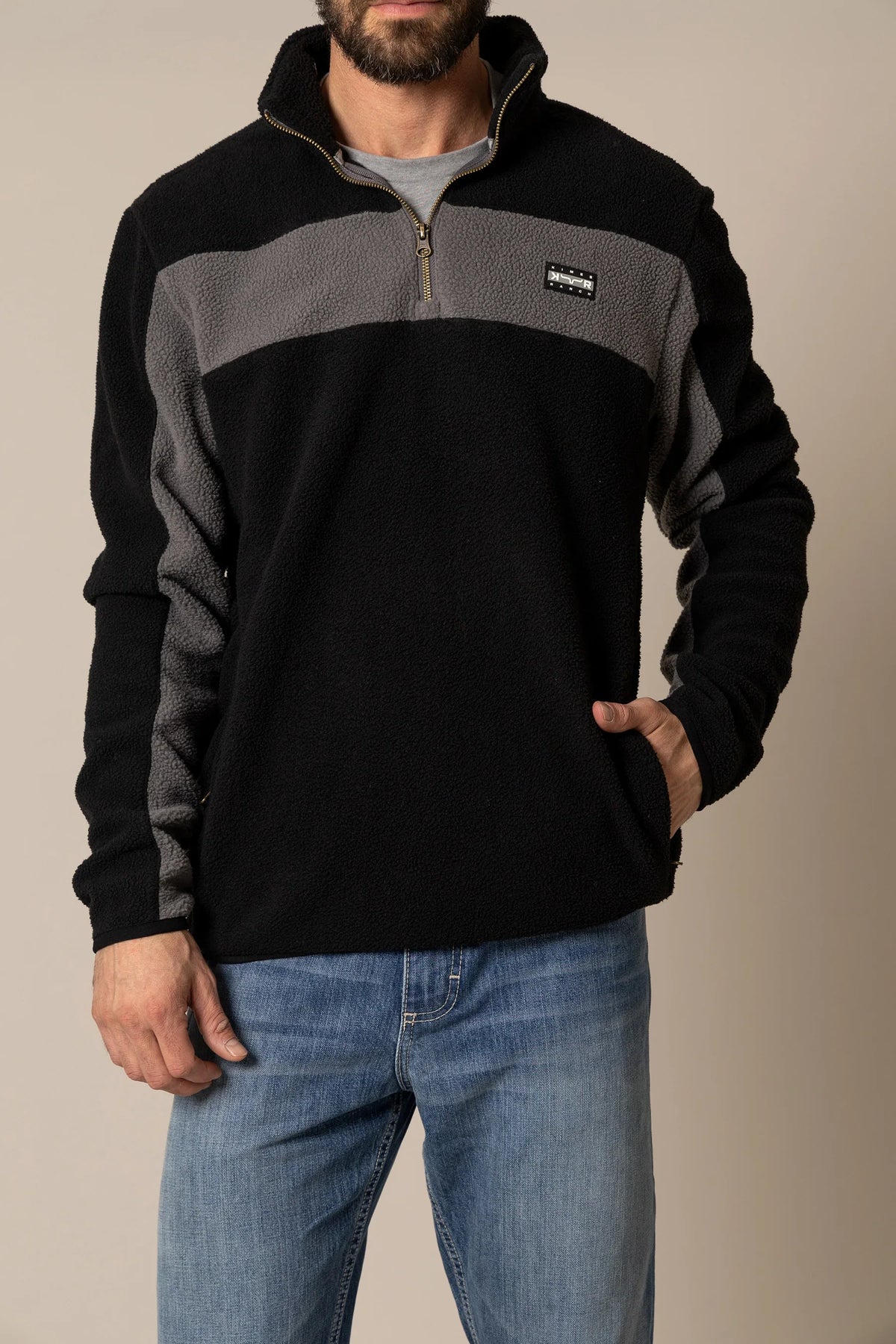 Kimes Ranch JMJ Quarter Zip sweatshirt in Black with grey colorblock shoulders and sleeves and a chest logo