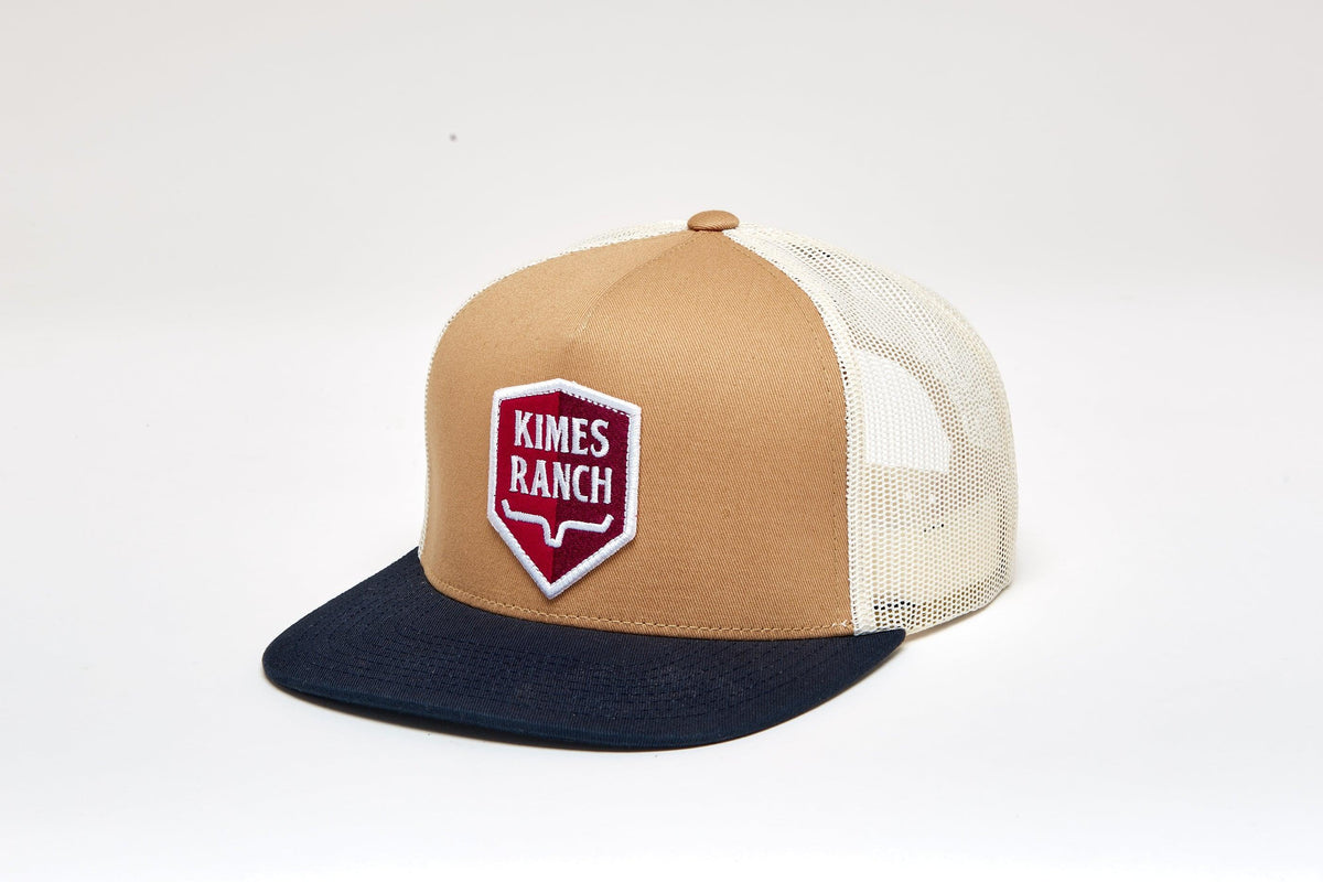 Kimes Ranch Jack Trucker Hat in Work Wear Brown, side view, with a navy brim and mesh back featuring the Kimes Ranch logo