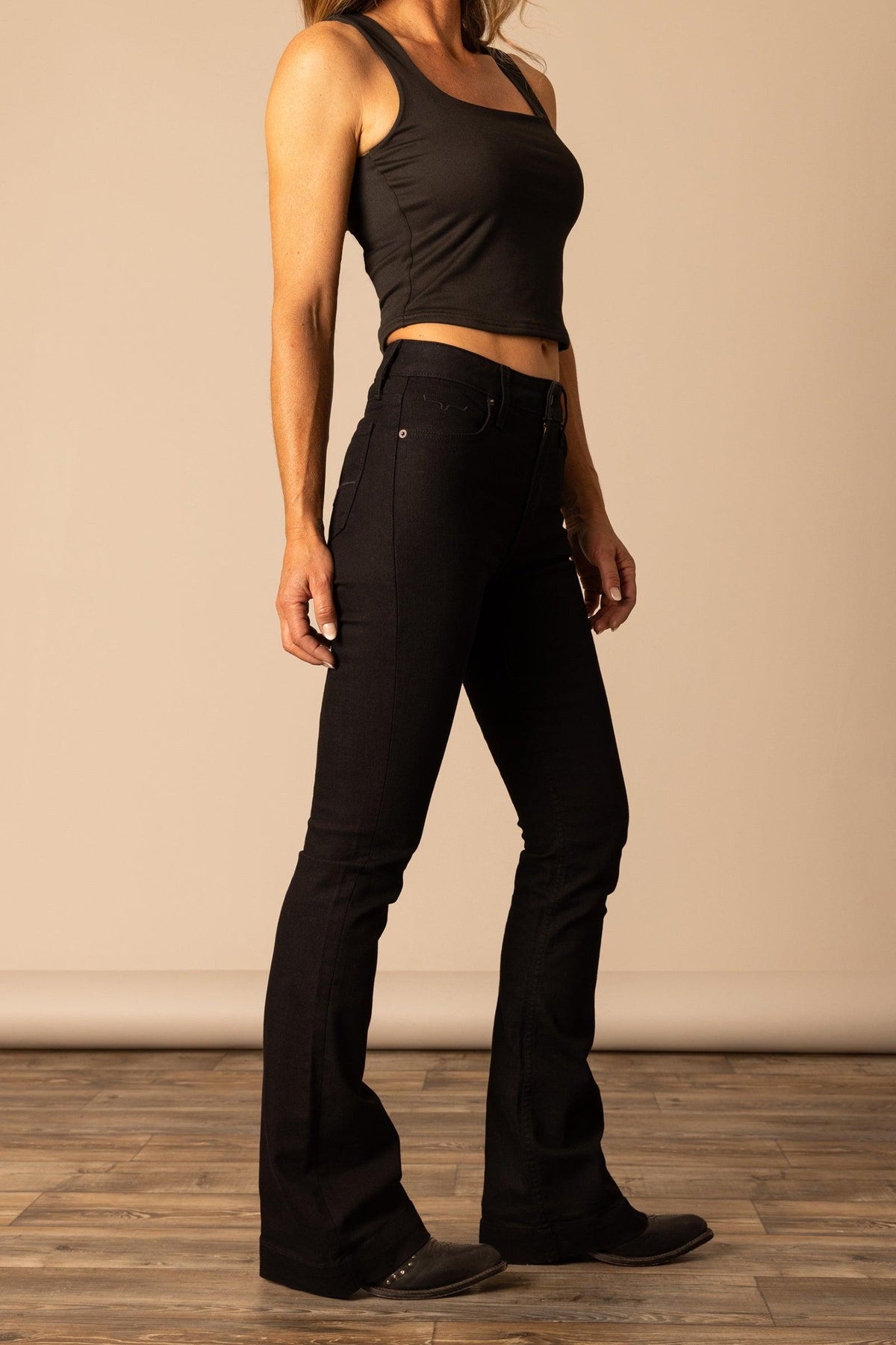 Kimes Ranch Jennifer jeans in Black, side view, with a flared leg and front pockets