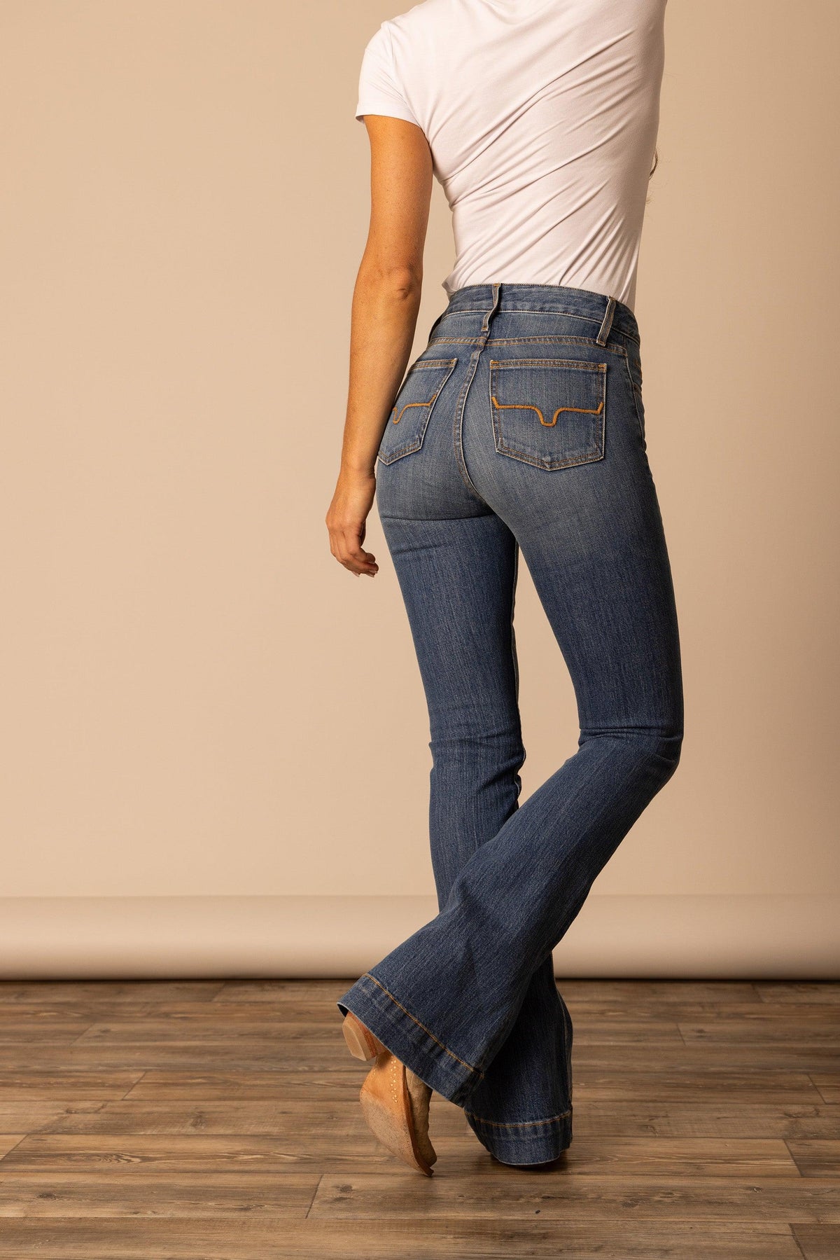 Kimes Ranch Jennifer jeans in Mid Wash, back view, with a flared leg and curved back pocket stitching