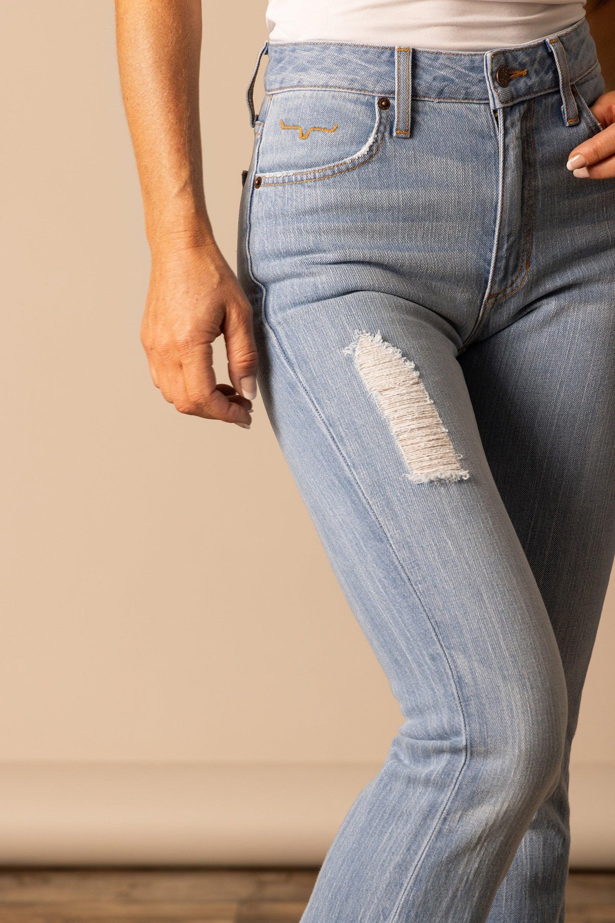 Kimes Ranch Jennifer jeans in Sugar Fade, side view, with a distressed thigh detail