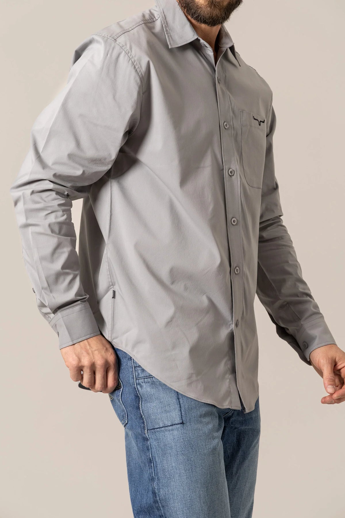 Kimes Ranch KR Team Dress Shirt in Grey, side view, with long sleeves and a chest pocket featuring the Kimes Ranch logo