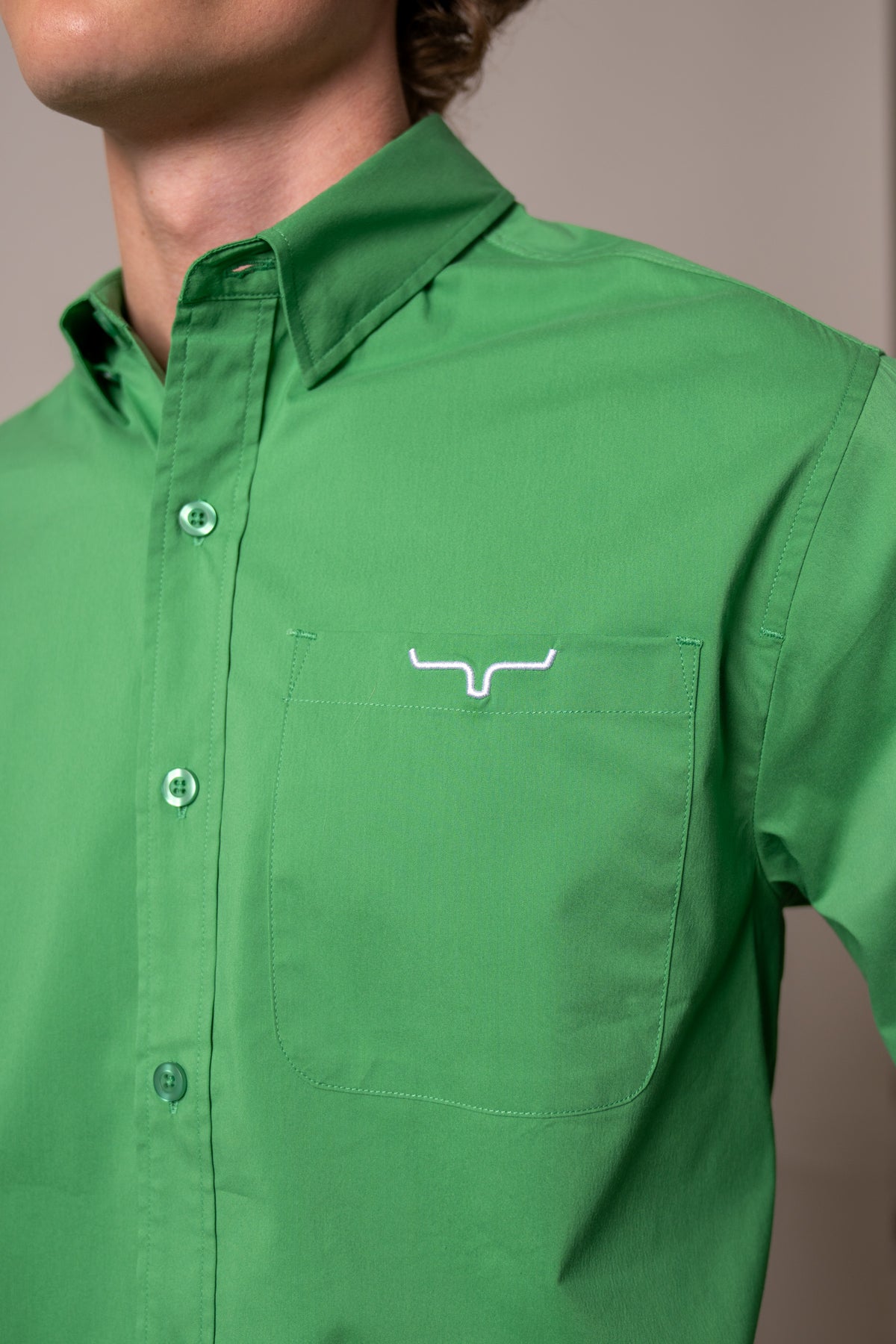 Kimes Ranch KR Team Dress Shirt in Kelly Green with a close-up of the chest pocket featuring the Kimes Ranch logo