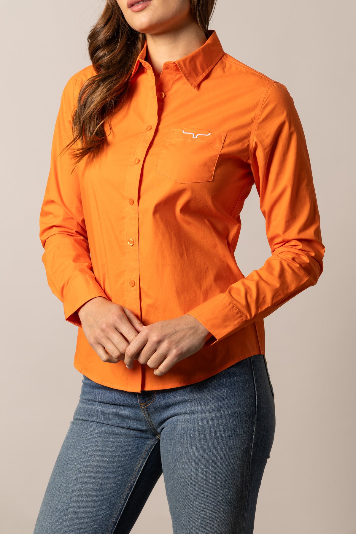Kimes Ranch Ladies KR Team Shirt in Vintage Orange with a button front and chest pocket with logo