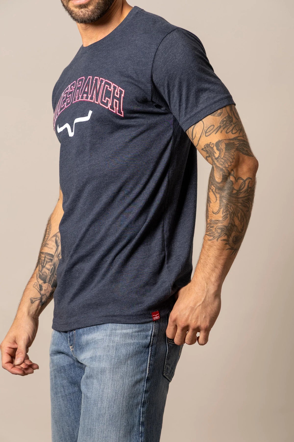 Kimes Ranch KR University shirt in Midnight Navy, side view, with a graphic featuring the brand name in red and white