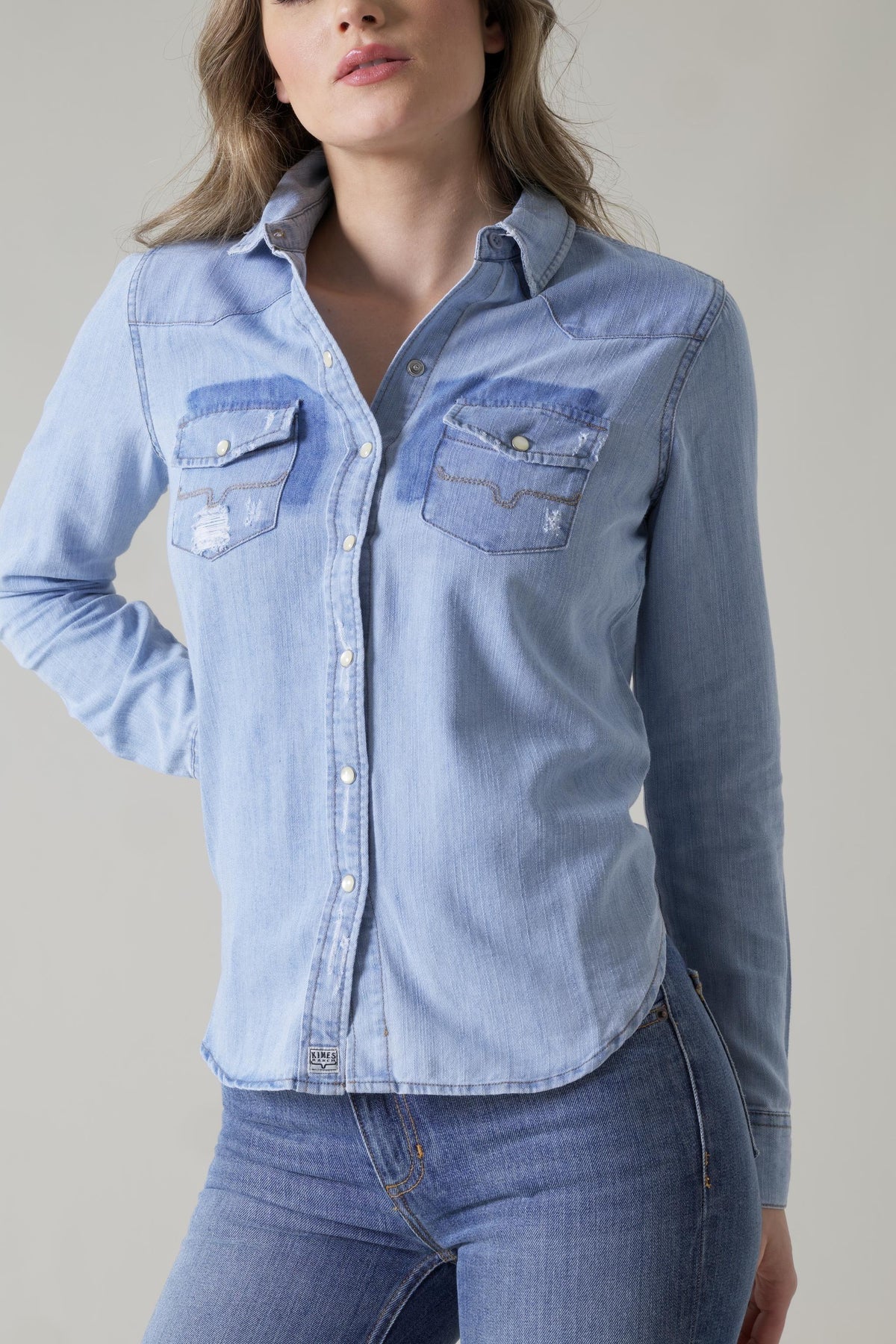 Kimes Ranch Kaycee Denim Top in light blue with a button front and two chest pockets with stitching