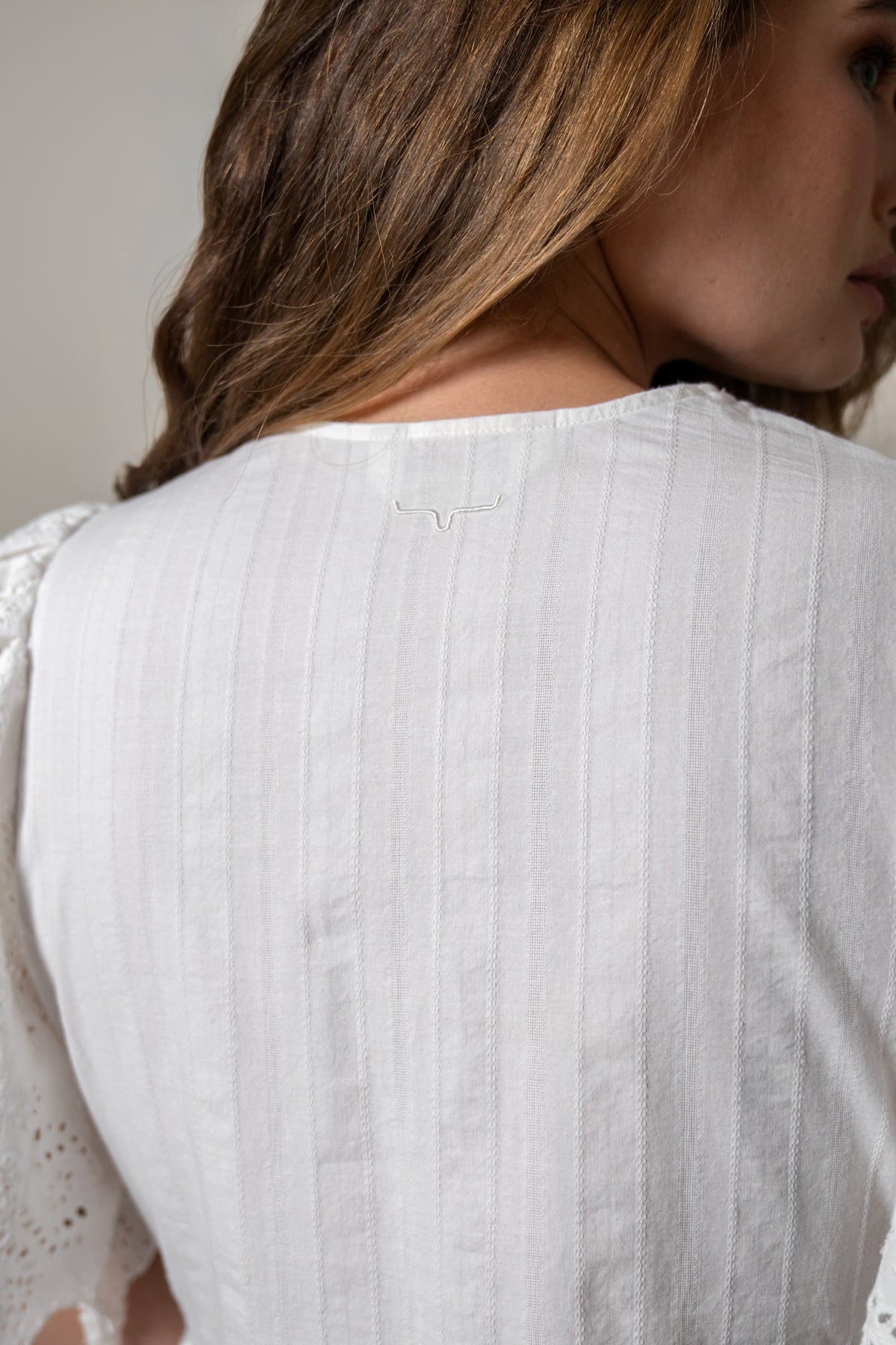 Kimes Ranch Kelsey dress in Pristine, back view, with a back yoke detail and the Kimes Ranch logo