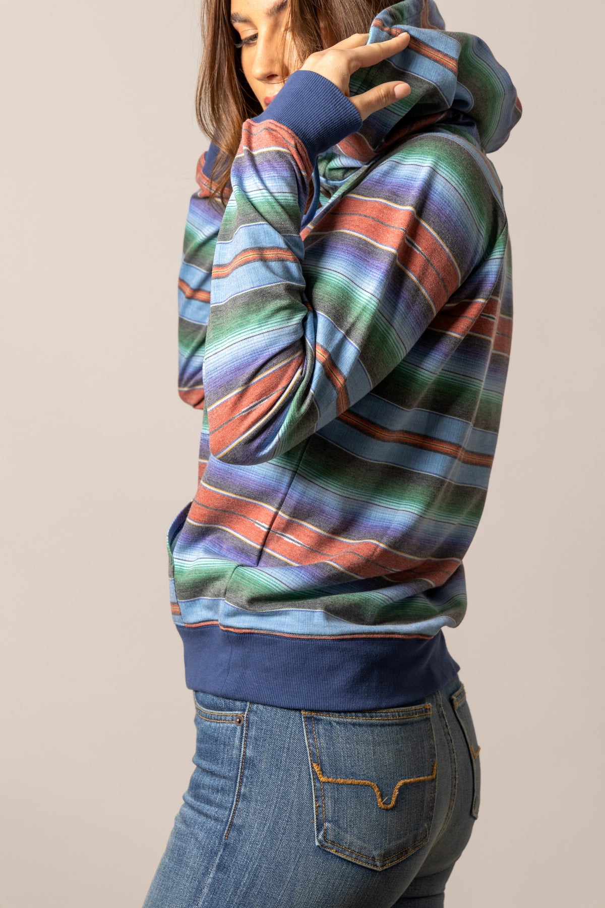 Kimes Ranch Kenzie Hoodie in Mid Blue, side view, with multicolor horizontal stripes and solid blue cuffs