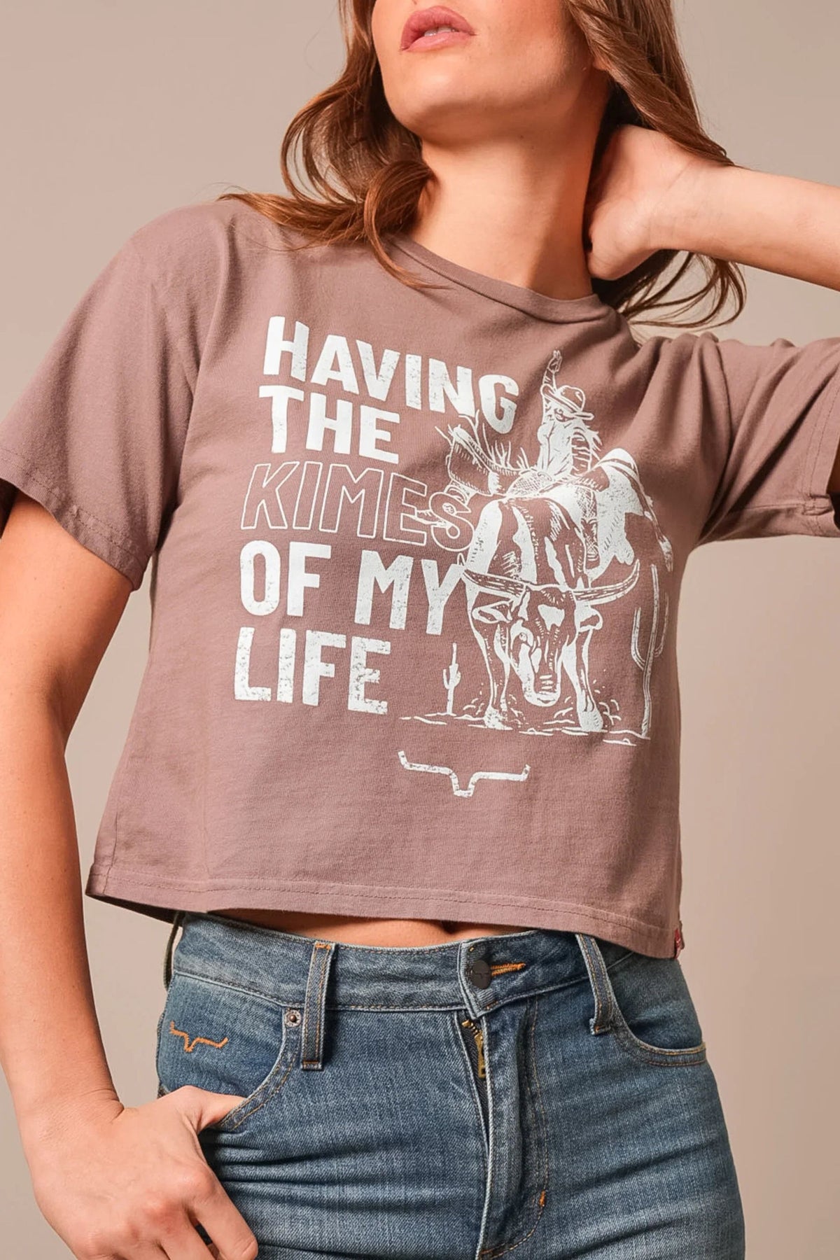 Kimes Ranch Kimes Of My Life shirt in Mocha with a graphic of a cowboy on a steer and the text Having the Kimes of My Life