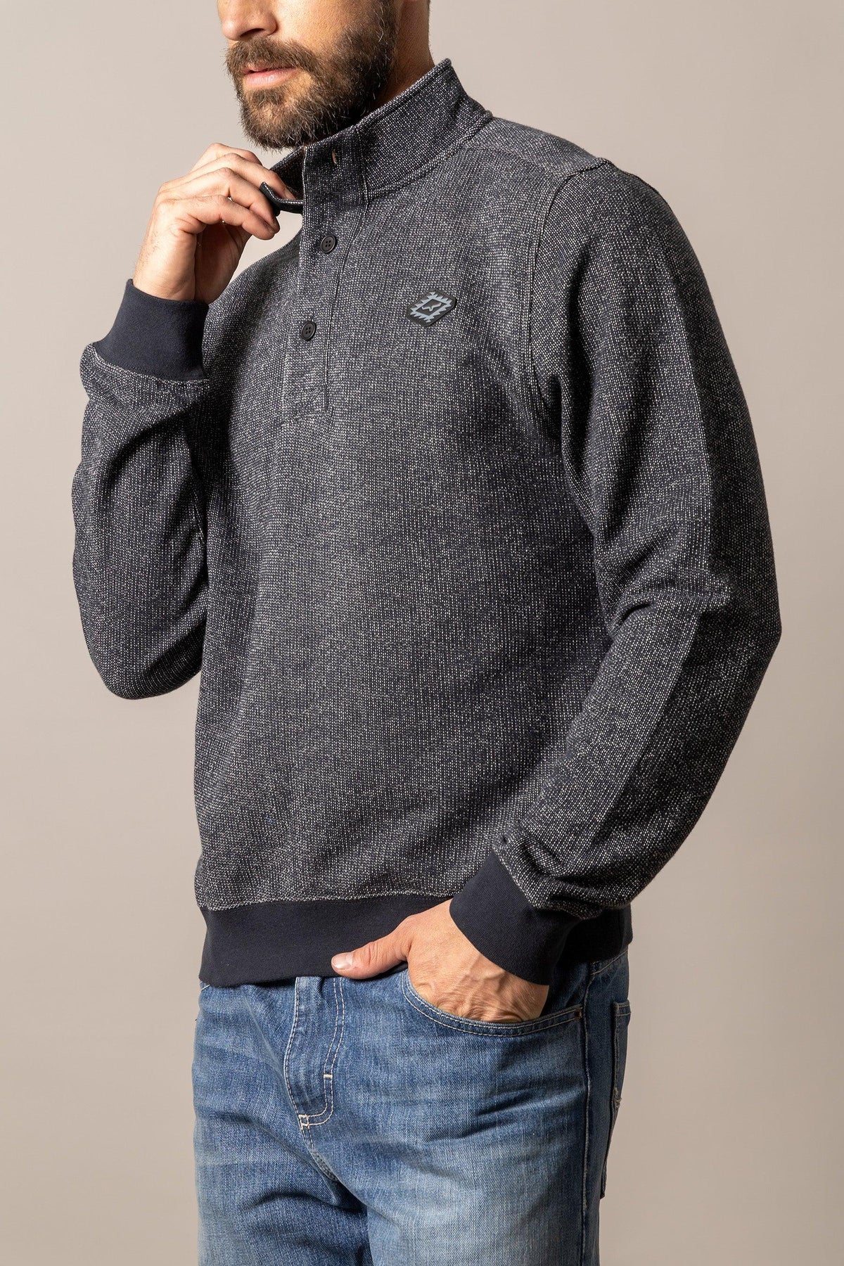 Kimes Ranch Kingswell sweatshirt in Black, side view, with a stand collar, button placket, and Kimes Ranch logo on the chest