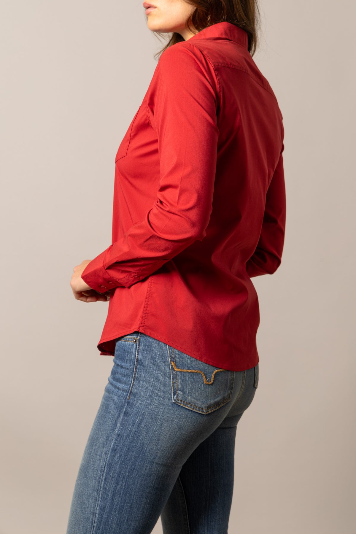 Kimes Ranch Ladies KR Team Shirt in Red, side view, with long sleeves and a curved hem