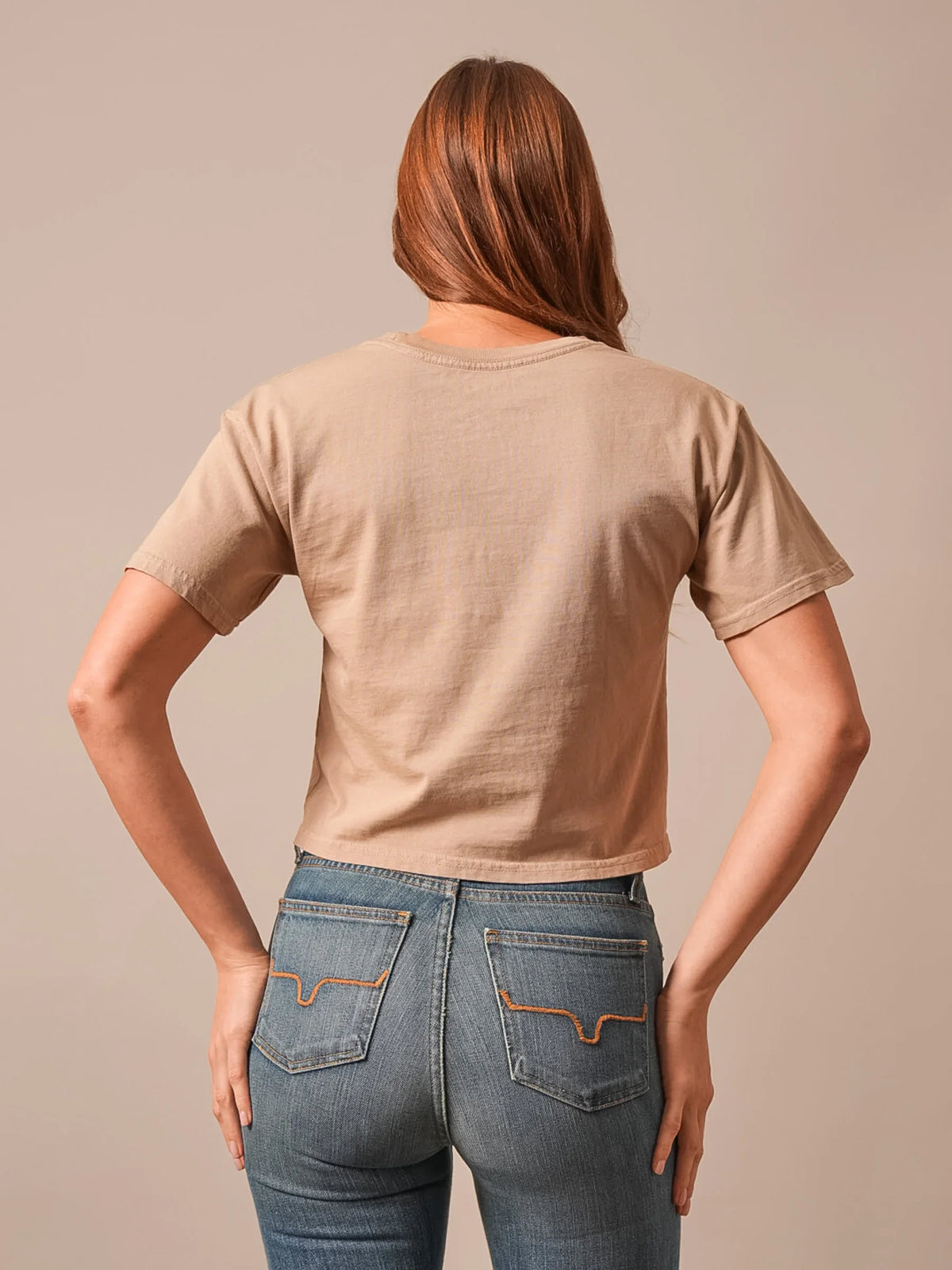 Kimes Ranch Lasso Script shirt in Tan, back view, showing the plain back with short sleeves and a crew neckline