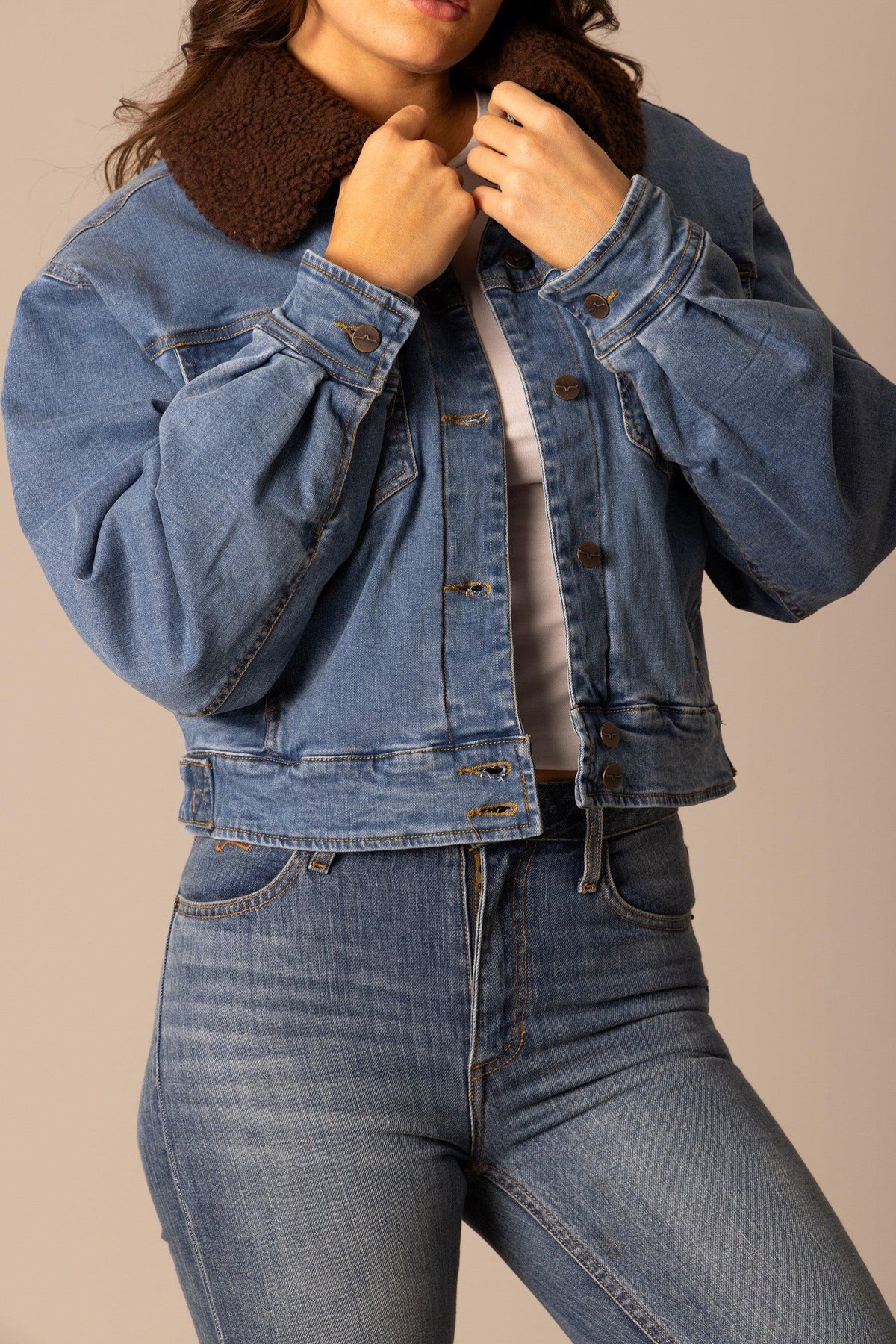 Kimes Ranch Leela Denim Jacket in Light Wash Indigo with a brown sherpa collar and button front