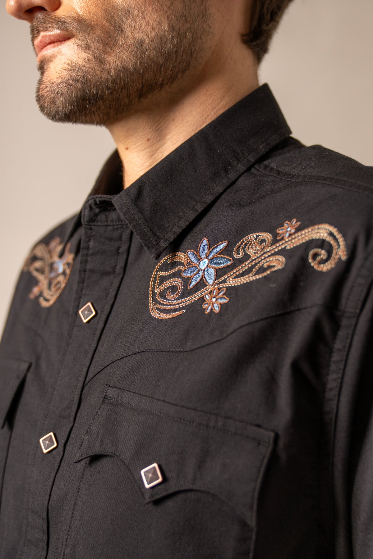 Kimes Ranch Leland, close-up, Black dress shirt with floral embroidery on the chest and yoke