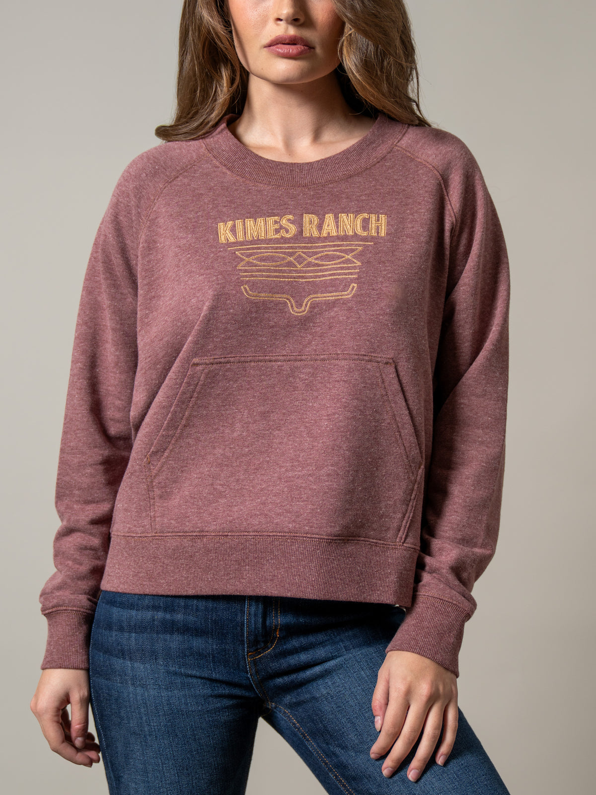 Kimes Ranch Lexie sweatshirt in Maroon with a crewneck, long sleeves, kangaroo pocket, and gold Kimes Ranch logo