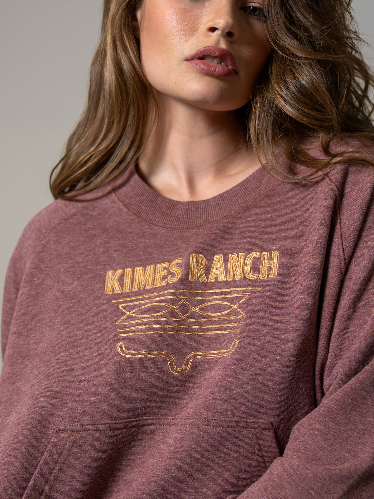 Kimes Ranch Lexie sweatshirt in Maroon, close-up, with a crewneck and embroidered Kimes Ranch logo
