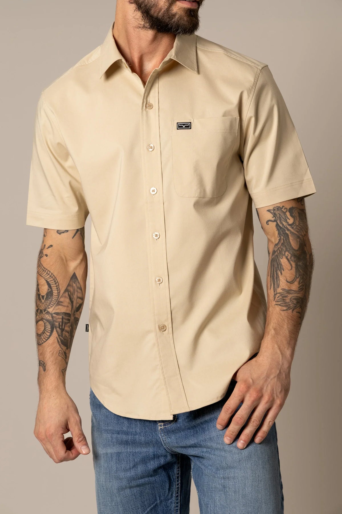 Kimes Ranch Linville Short Sleeve Dress Shirt in Tan with a chest pocket and logo patch