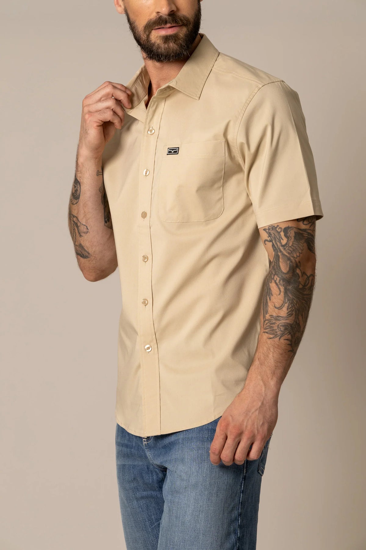 Kimes Ranch Linville Short Sleeve Dress Shirt in Tan with a chest pocket and logo patch