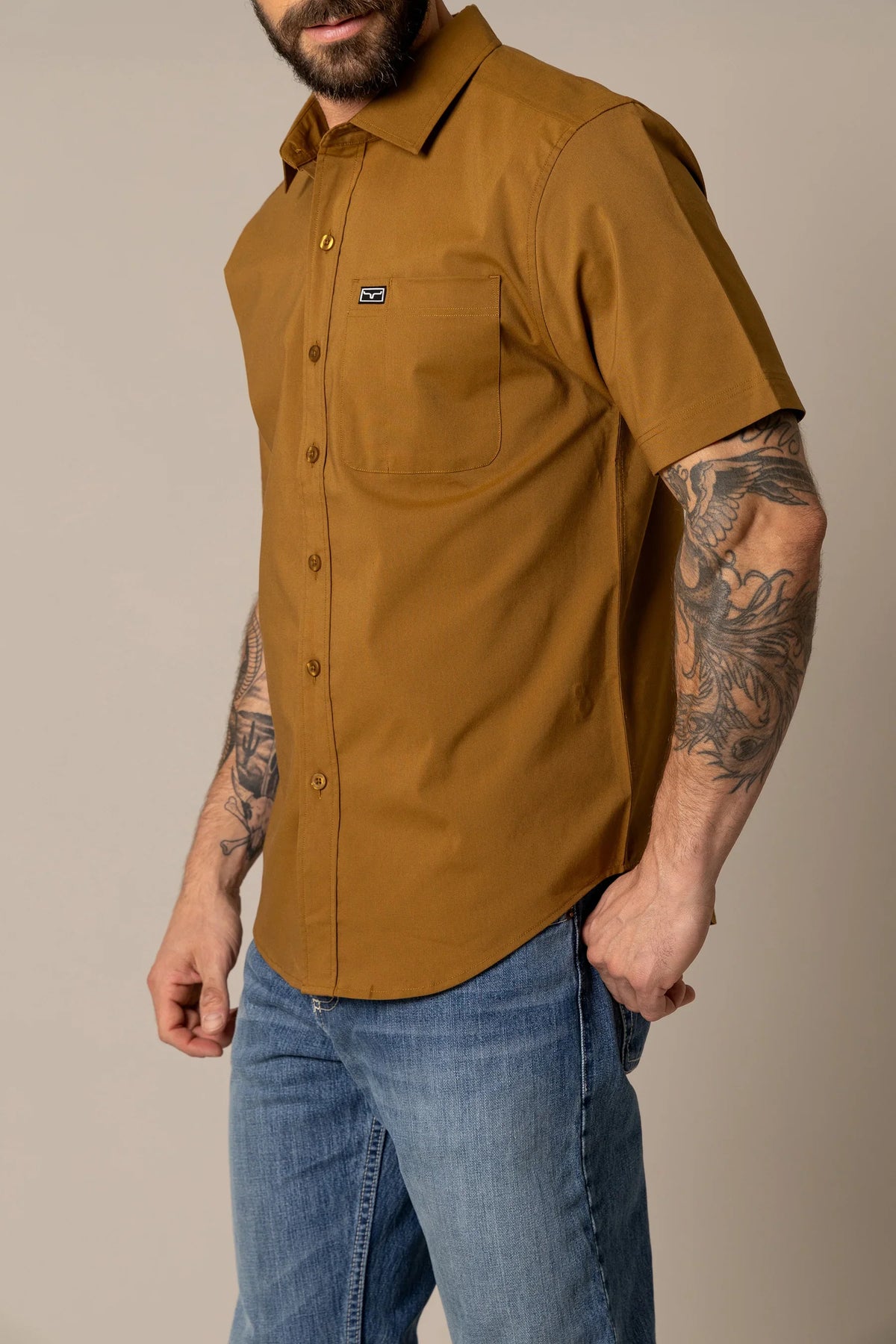 Kimes Ranch Linville Short Sleeve Dress Shirt in Work Wear Brown, side view, with a chest pocket and Kimes Ranch logo