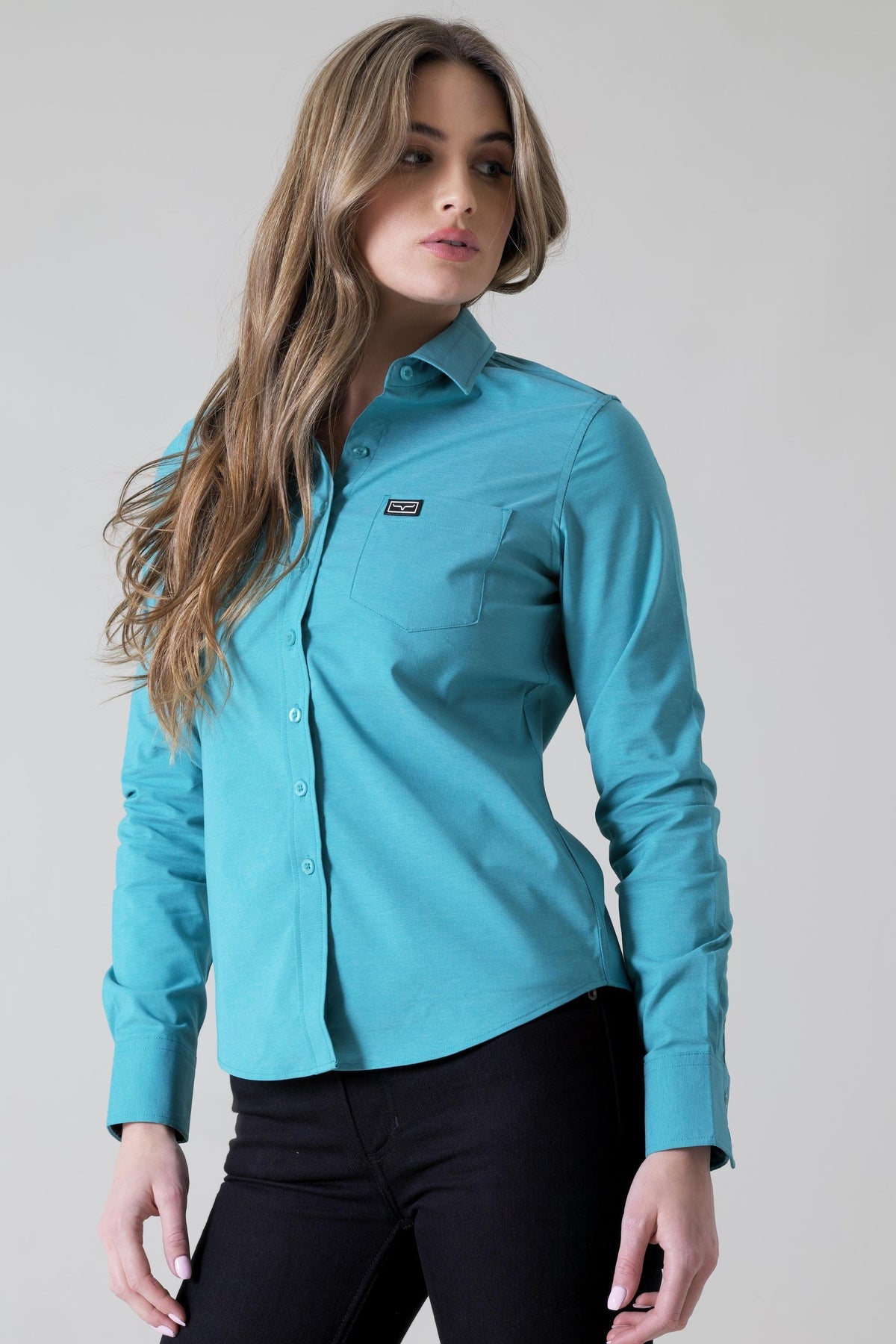 Kimes Ranch Ladies Linville Teal long sleeve button up top with a chest pocket and logo patch