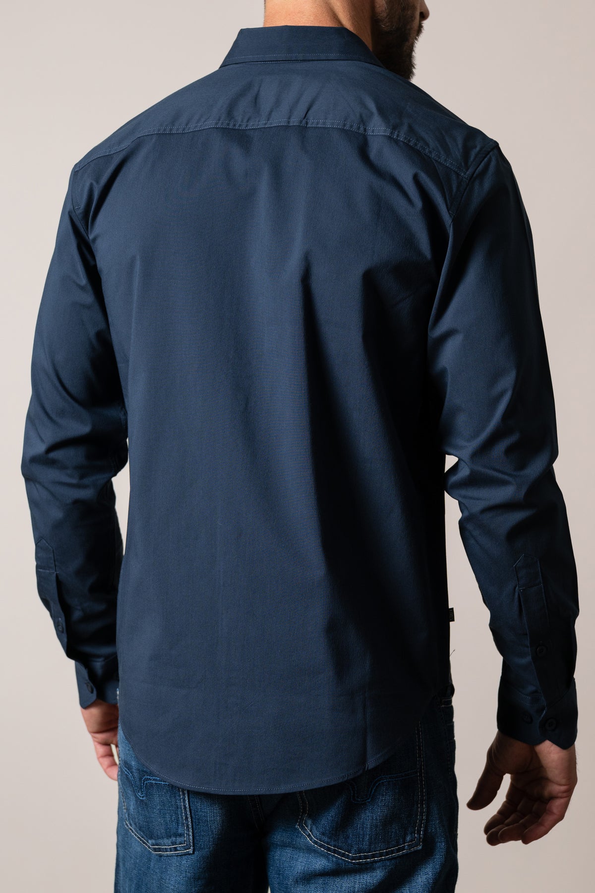 Kimes Ranch Linville Long Sleeve Dress Shirt in Navy, back view, with a back yoke and button cuffs