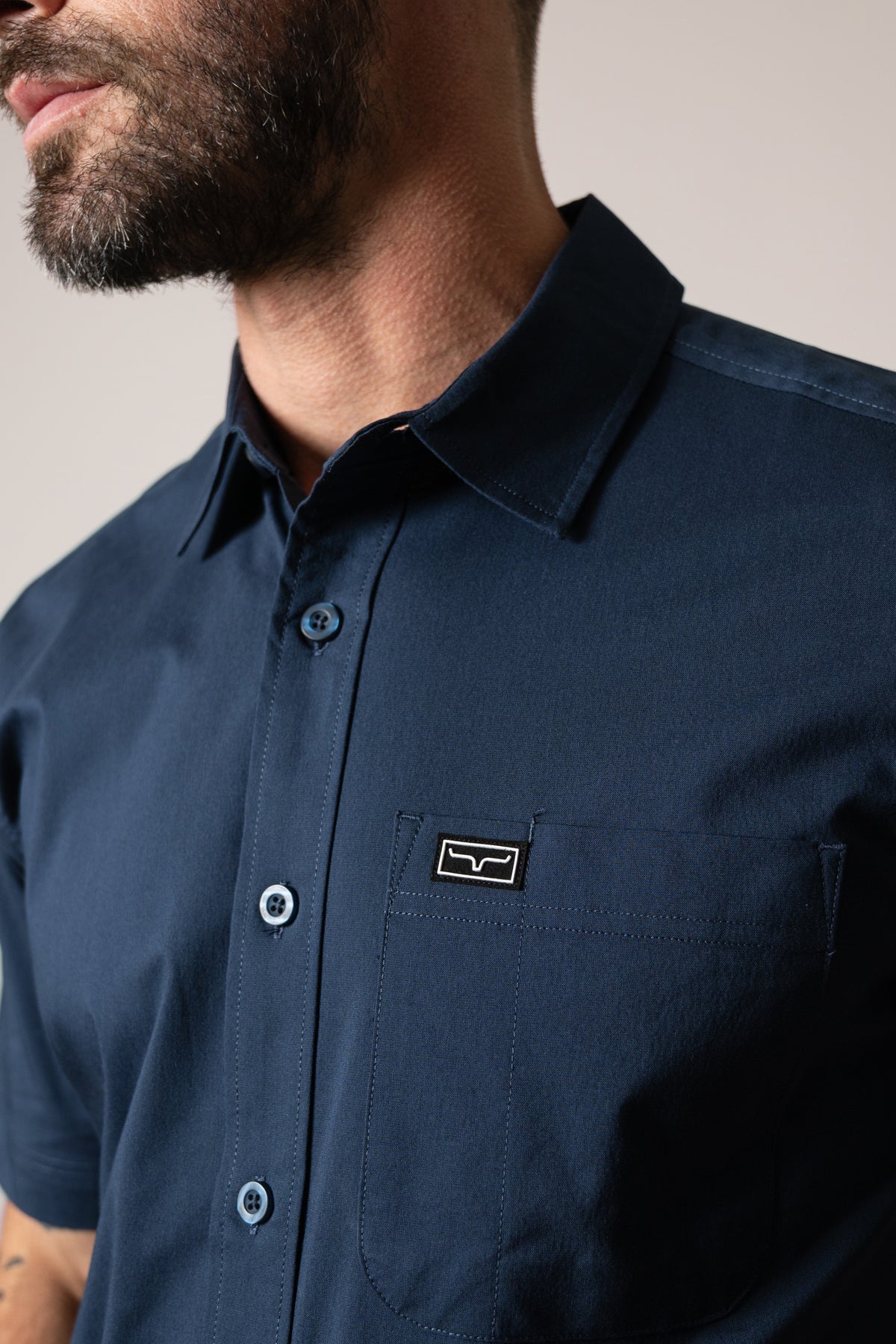 Kimes Ranch Linville Short Sleeve Dress Shirt in Navy with a close-up of the collar and chest pocket