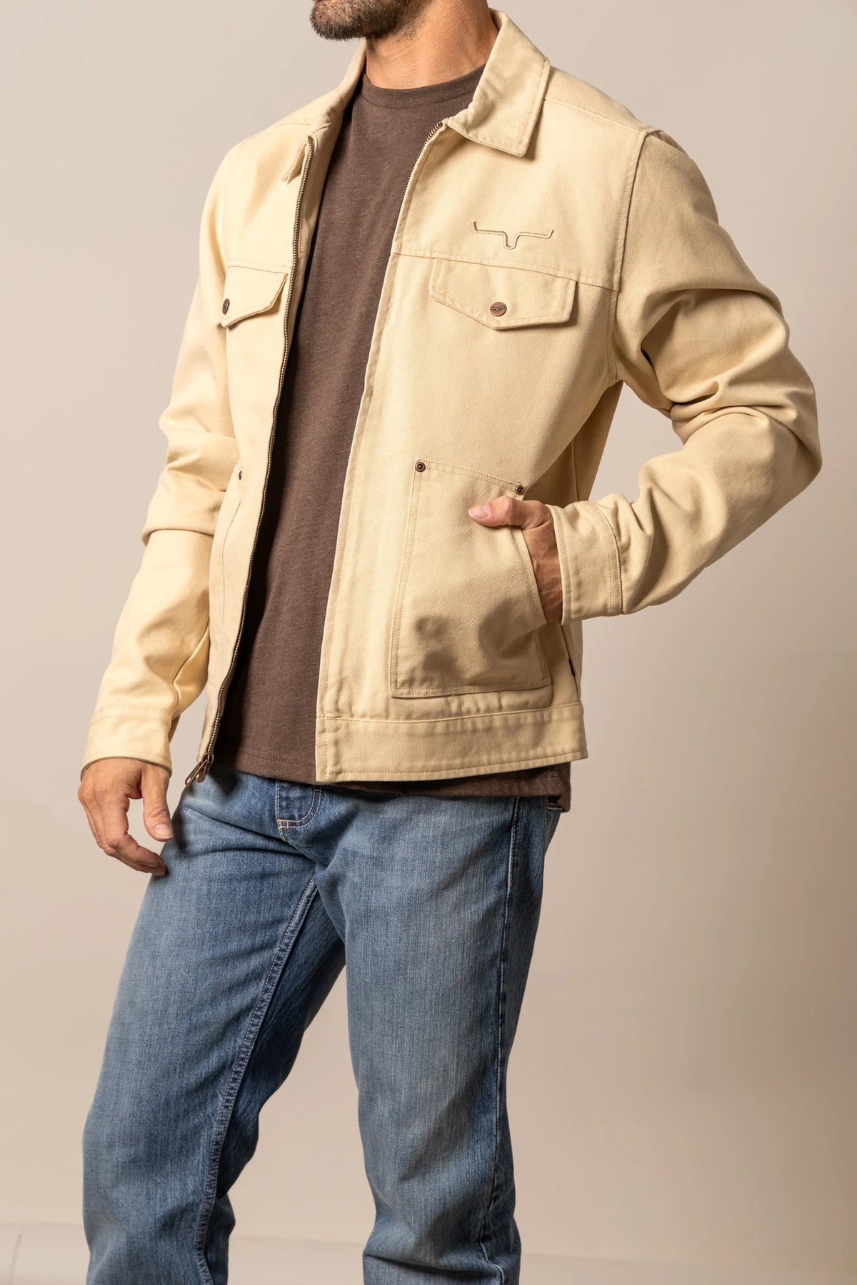 Kimes Ranch Logan Jacket in Tan with a zip front, collar, and chest pocket with the Kimes Ranch logo